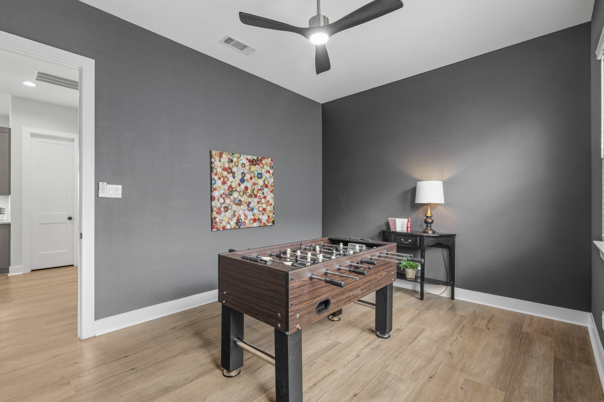 Normally, it is difficult to find a Single Story home that offers this needed extra space, especially one like this that is finished with high-end LVP floors, custom paint and a ceiling fan that matches the others throughout the home. It ready for your giant TV with a wall outlet and installed TV bracket.