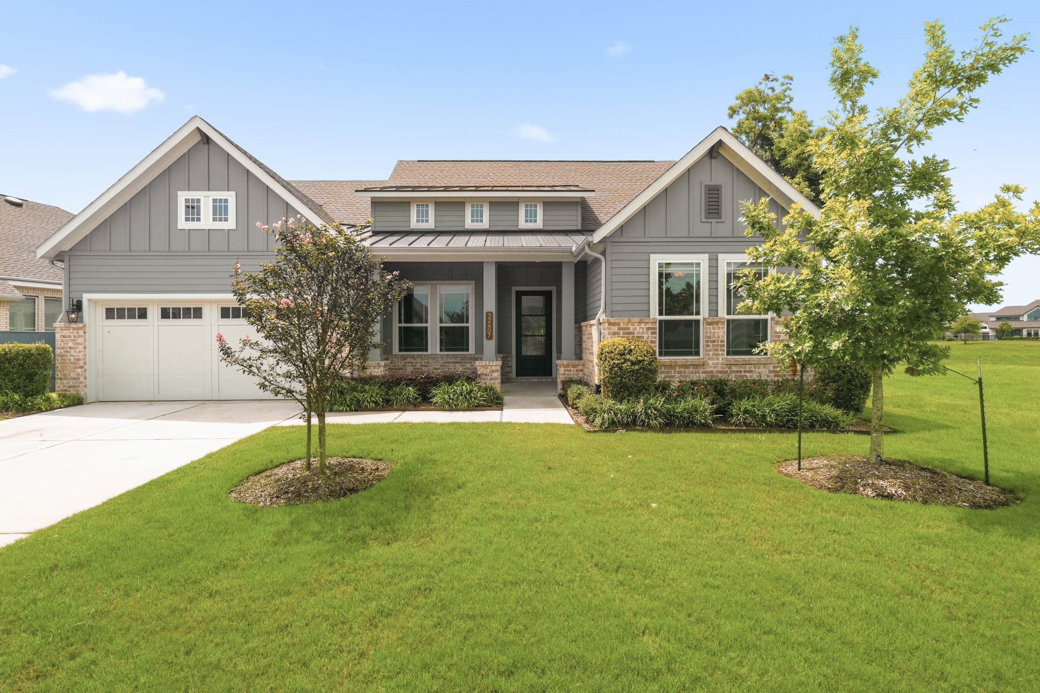 This stunning Single-Story home showcases a superb architectural blend of soaring gable roofs, a striking metal shed roof, upgraded brick and lush landscaping that enhance the home's outstanding curb appeal.