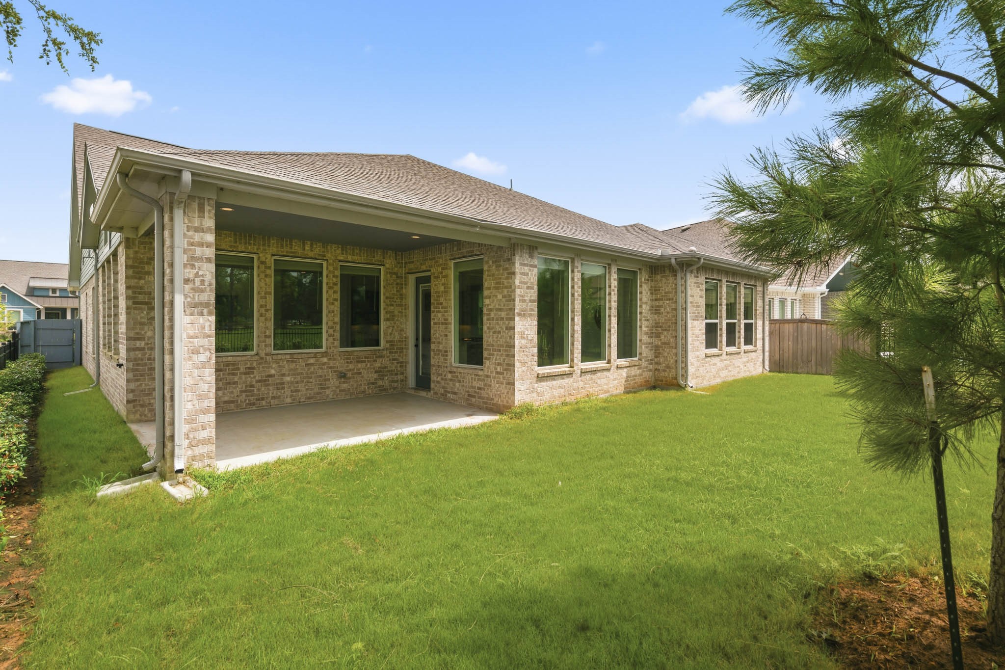 This covered Porch is inset under the roof line and provides a stronger look along with better shelter from the elements and shade from the hot sun. Whether furnished with cozy lounge seating for morning coffee or an outdoor dining table for gatherings, this inviting outdoor space allows you to enjoy the beauty of nature just beyond your Backyard.