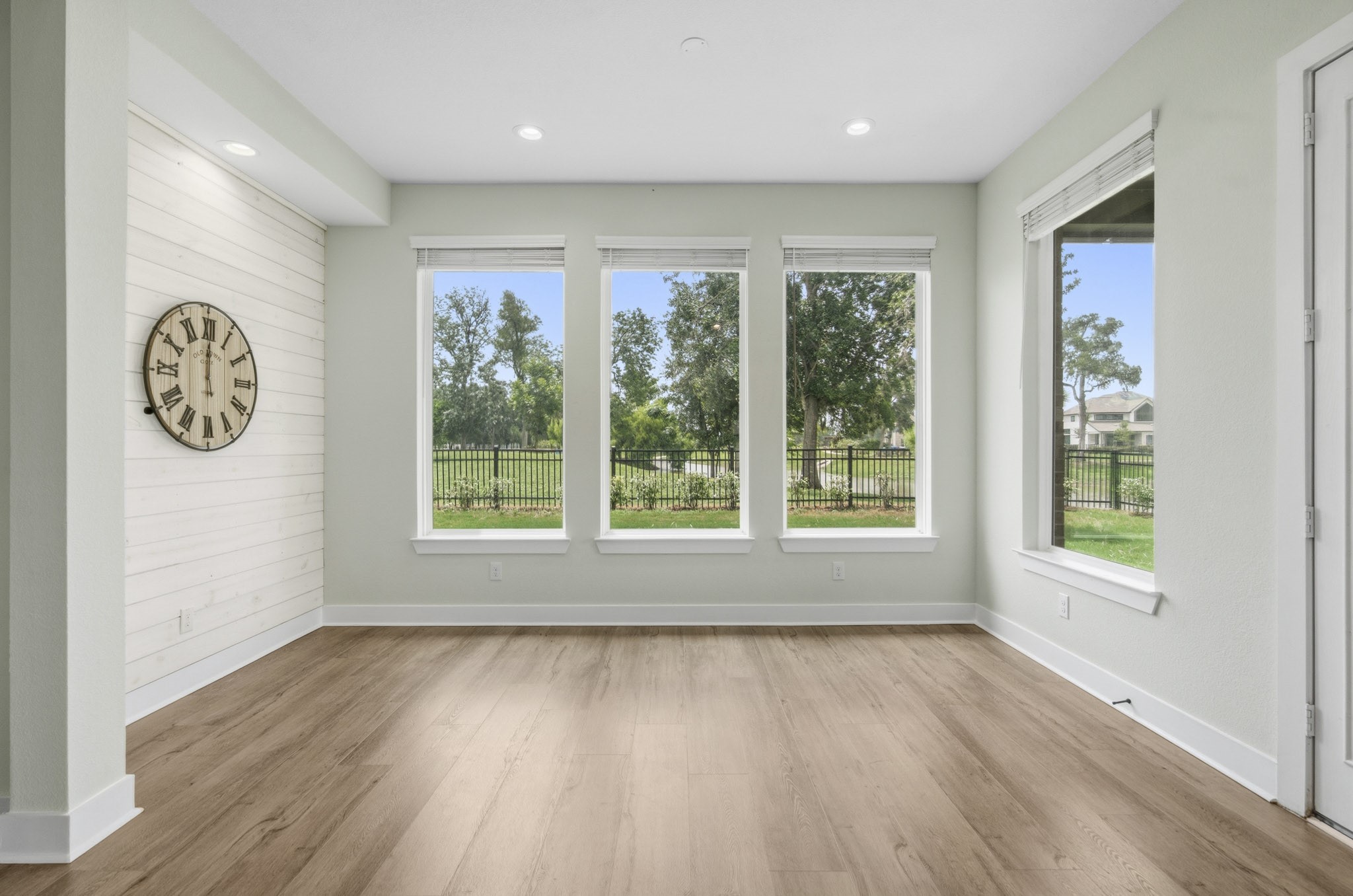 The Kitchen flows to this stunning Dining Room the offers a custom shiplap wall that softens. Its a space where the eye is drawn thru a quartet of huge plate glass windows that soothe the mind with spectacular viewswhere you can be lost in thought listening to the songbirds while watching the squirrels at play.
