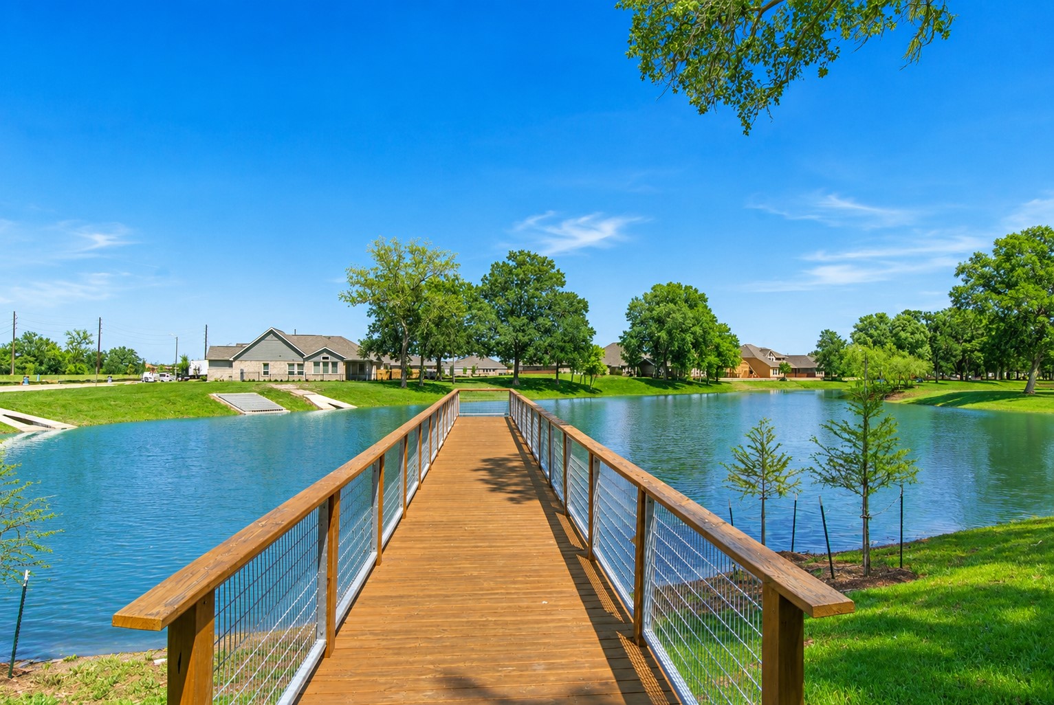 The home is on the left and is located directly across from both this fabulous fishing pier, that is both a picturesque focal point and a unique neighborhood amenity, that offers a daily reminder of the tranquil lakefront lifestyle that makes this home so special.