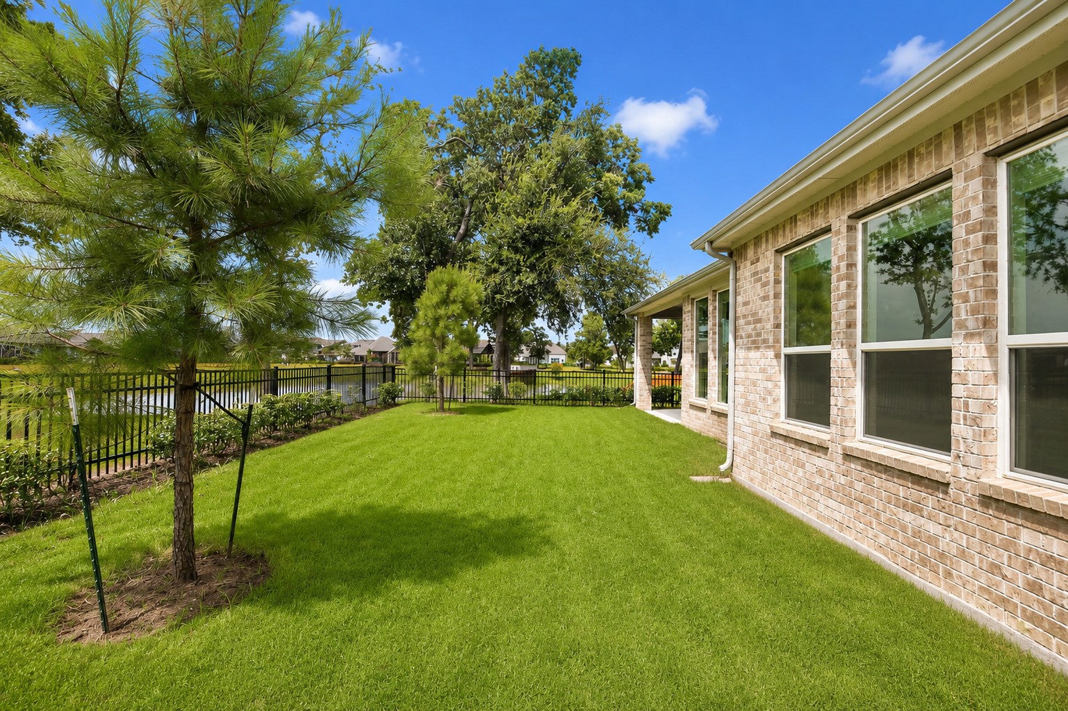 This view captures the windows from the Primary Bedroom that overlook the backyard, in addition to the trees and the length of the this extraordinary Lot.