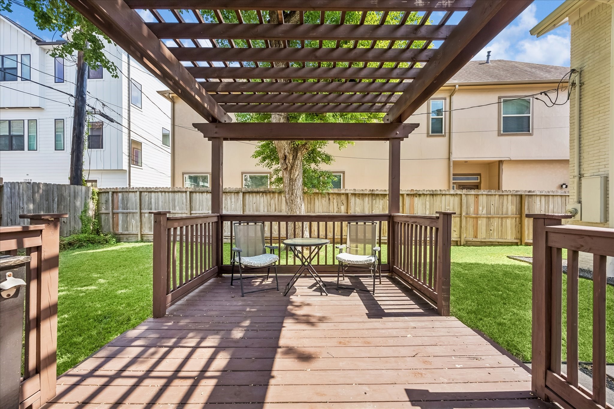 Wood pergola creates a shaded outdoor gathering spot with room for dining, lounging, or weekend get-togethers.