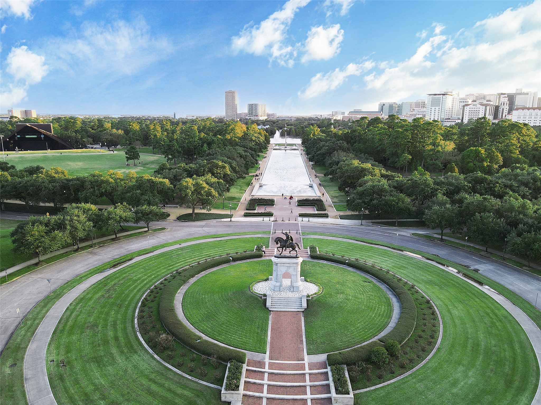 Hermann Park's iconic reflection pool and Sam Houston statue frame a sweeping view of the Texas Medical Center skyline, one of Houston's most beloved green spaces right at your doorstep.