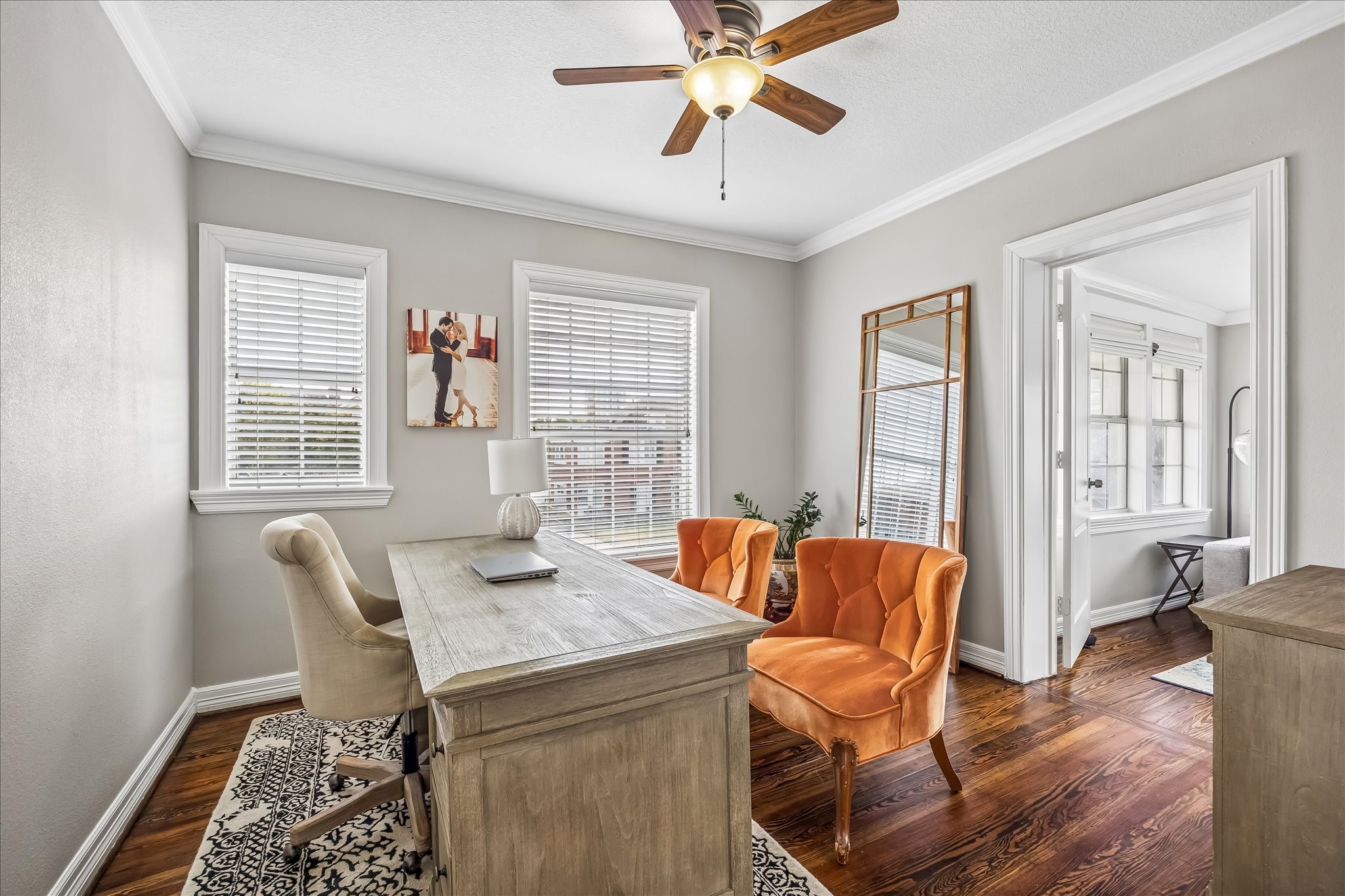 Upstairs bedroom is currently styled as a home office, with multiple windows and a comfortable footprint for a dedicated workspace.