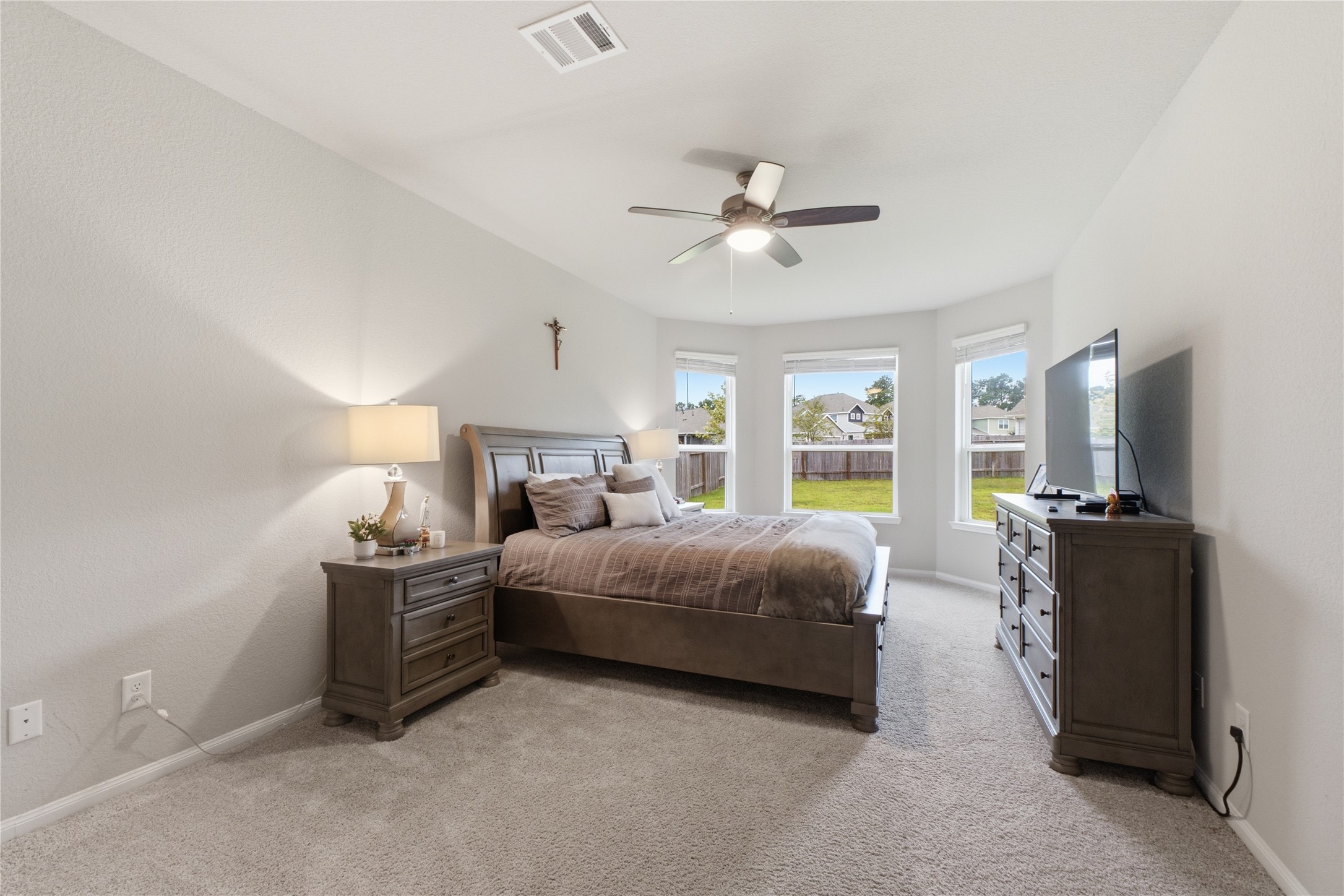 Primary bedroom with bay windows.