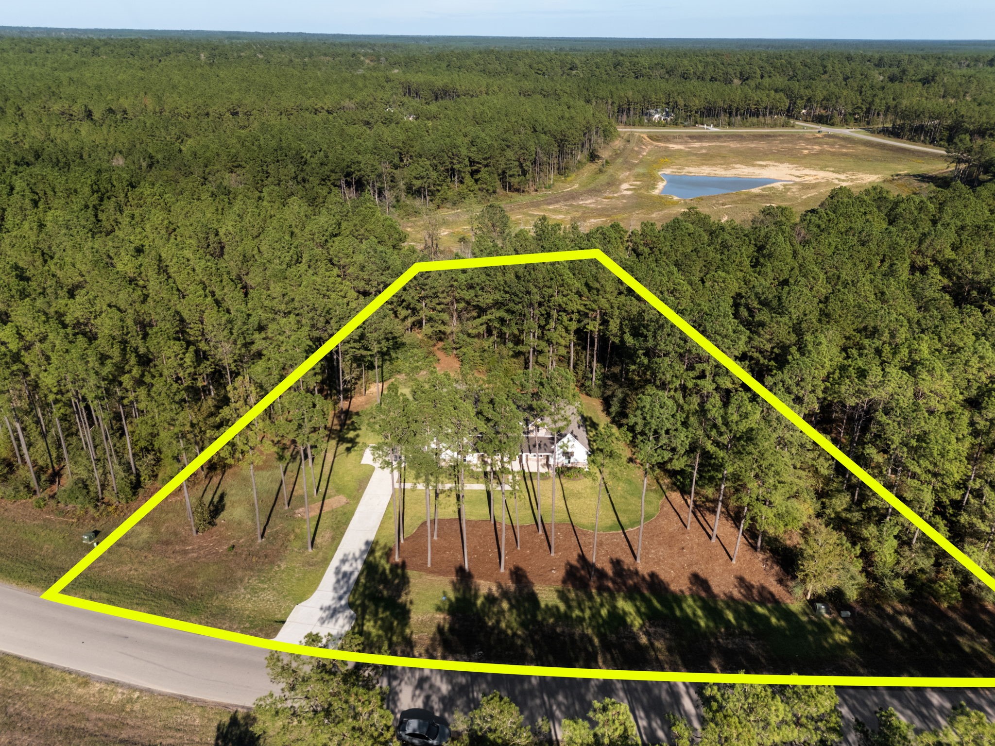 This aerial view highlights the approximate property boundaries on this expansive 1.9-acre homesite.