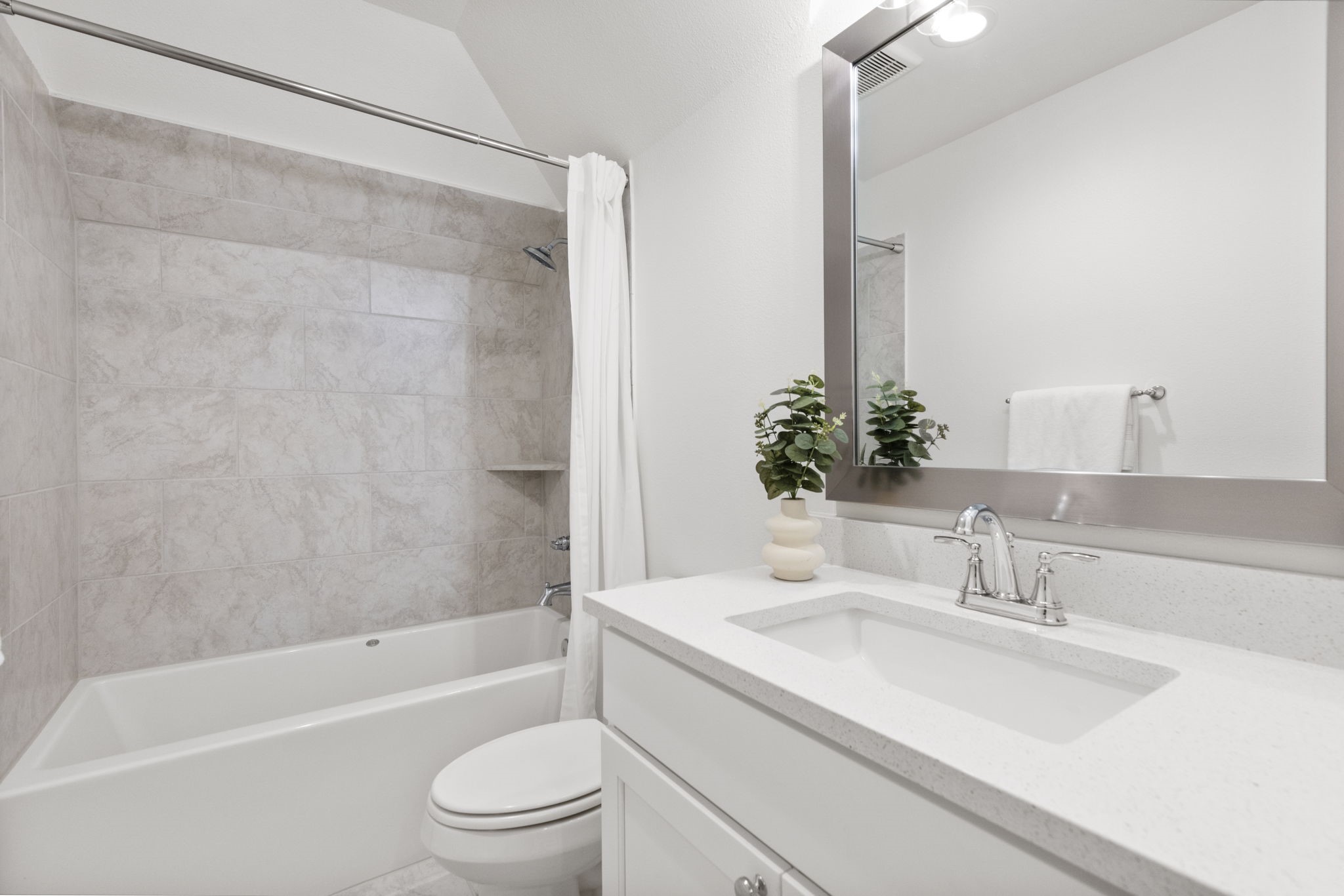 Bathroom three is crisp and fresh looking and has a tub/shower combo.