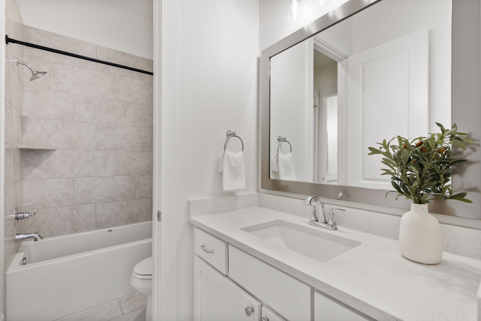 Bathroom two is light and bright with modern vanity and a tub/shower combo.