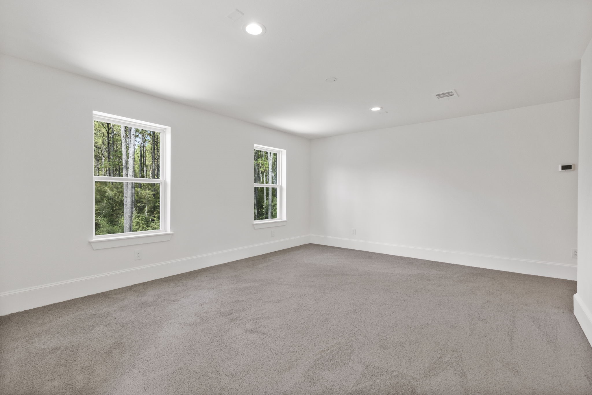 This expansive game room offers ample space for both lounge furniture and multiple game tables.