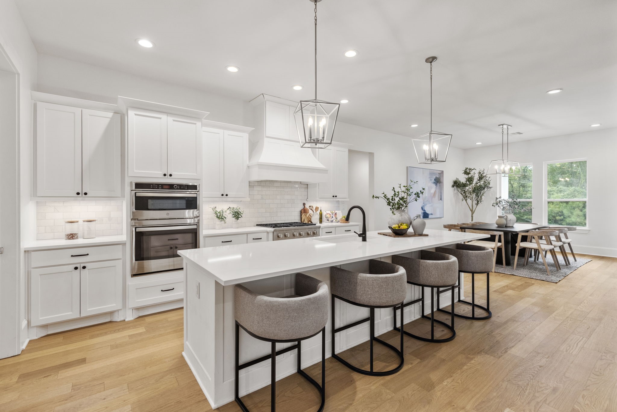 The premium stainless steel appliances offer a modern, sleek aesthetic that perfectly complements the upscale marble subway tile backsplash.