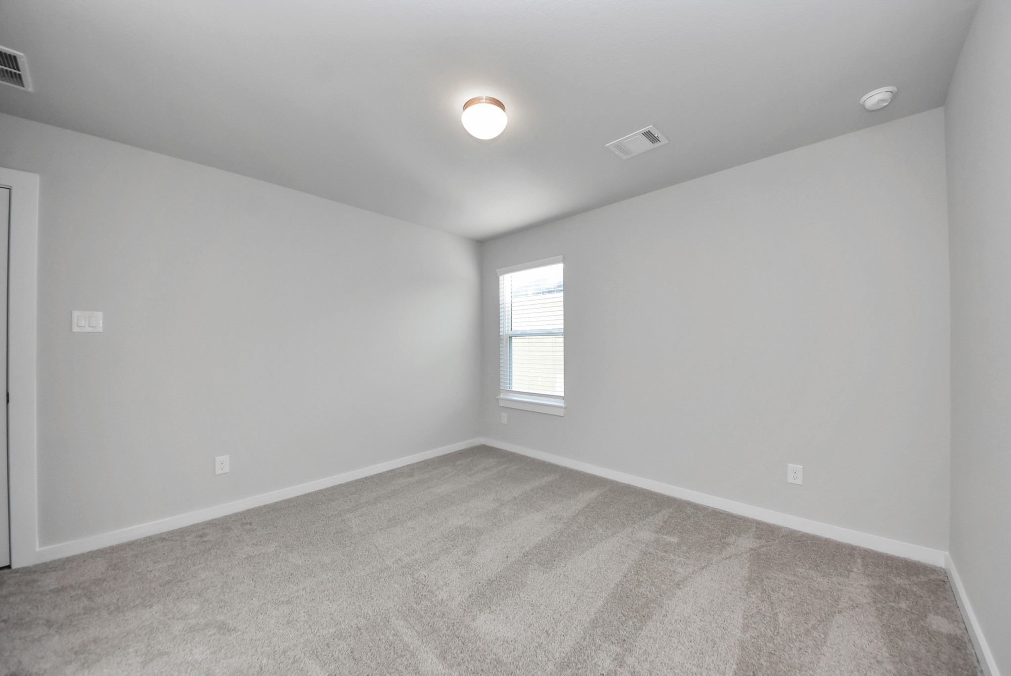 Generously sized secondary bedrooms featuring spacious closets, soft and inviting carpeting underfoot, large windows allowing plenty of natural light, and the added touch of privacy blinds for your personal retreat.