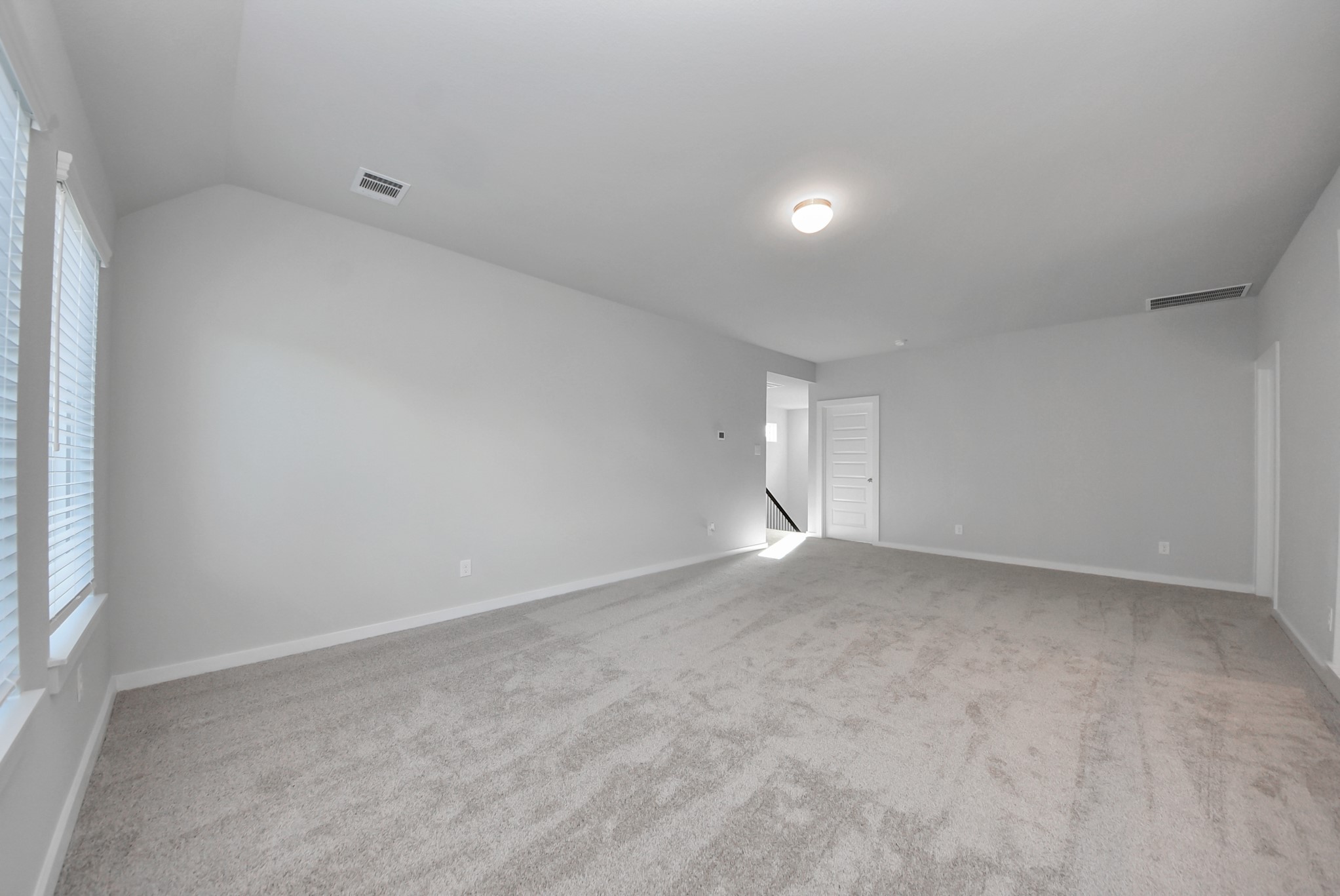 Ascend to relaxation in this fantastic game room! Ideal for both casual gatherings and adult gaming, it boasts plush carpet, lofty ceilings, custom paint, and ample windows for abundant natural light