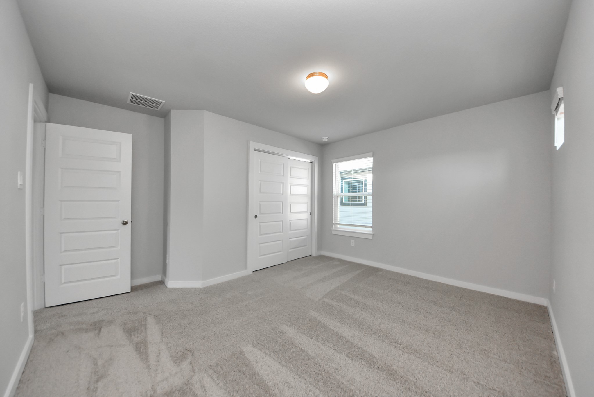 Generously sized secondary bedrooms featuring spacious closets, soft and inviting carpeting underfoot, large windows allowing plenty of natural light, and the added touch of privacy blinds for your personal retreat.
