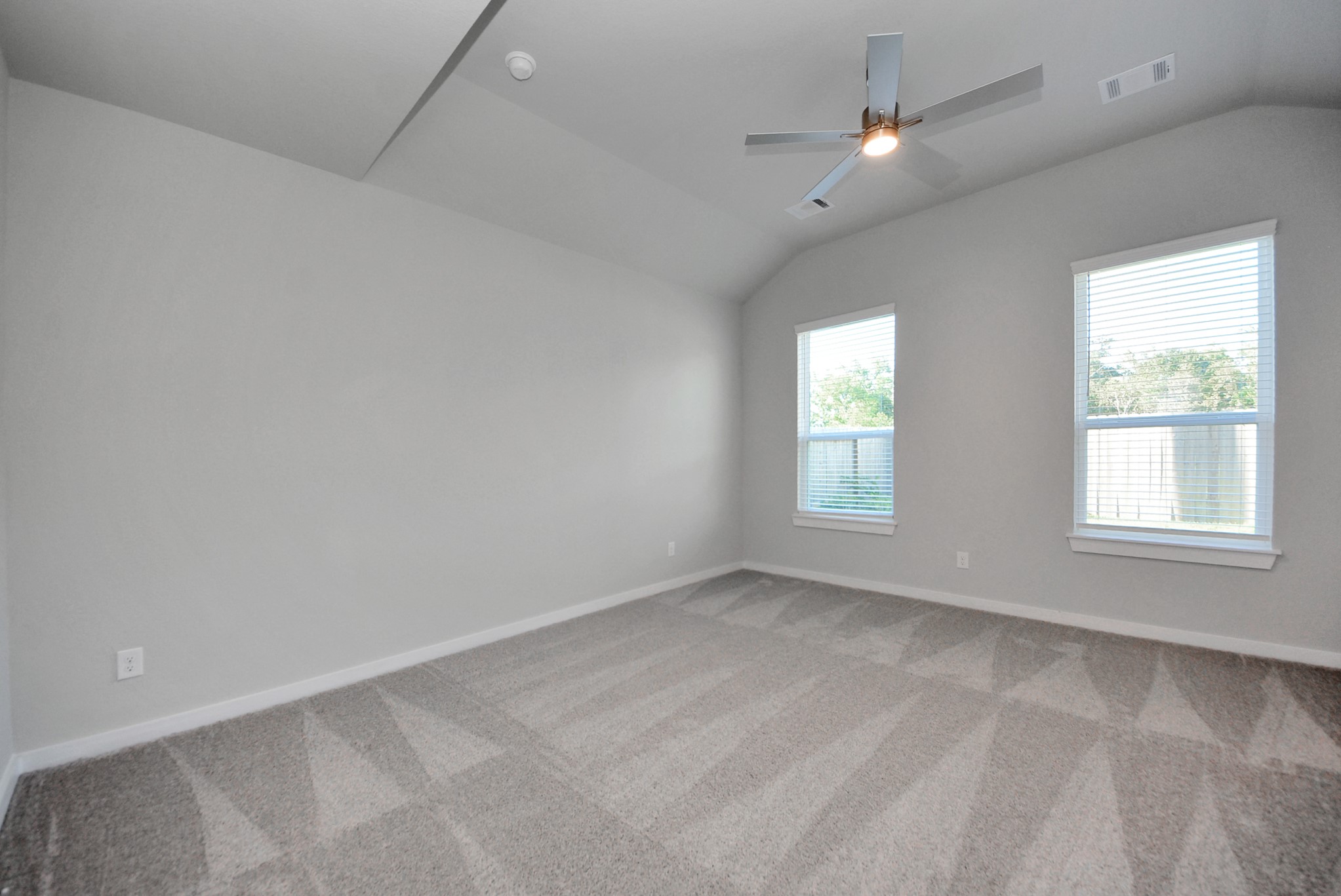 Retreat to the luxurious primary suite, your perfect escape for unwinding after a long day. Located on the first floor, this spacious room features plush carpeting, calming paint tones, high ceilings, and large windows with privacy blinds.
