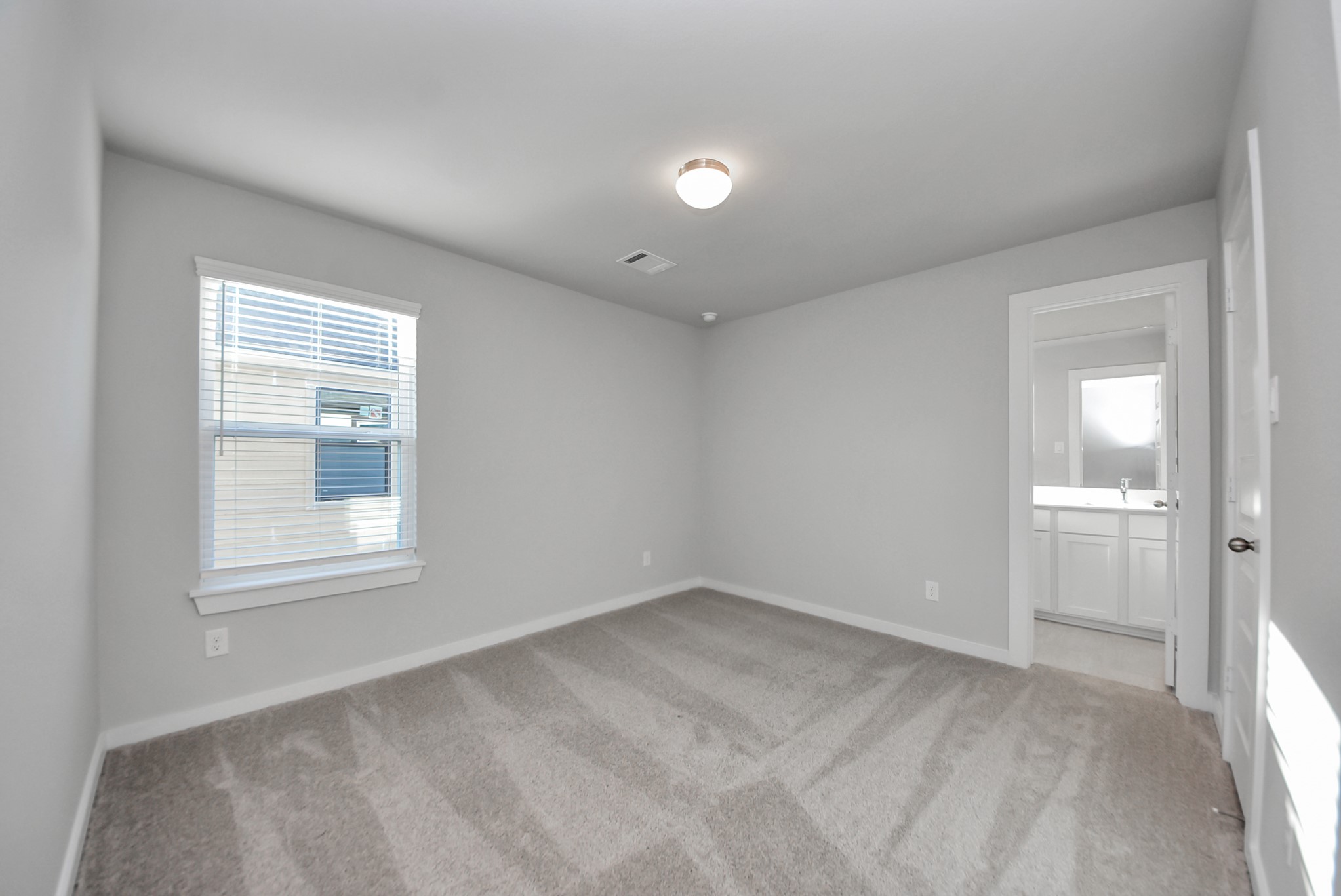 Generously sized secondary bedrooms featuring spacious closets, soft and inviting carpeting underfoot, large windows allowing plenty of natural light, and the added touch of privacy blinds for your personal retreat.