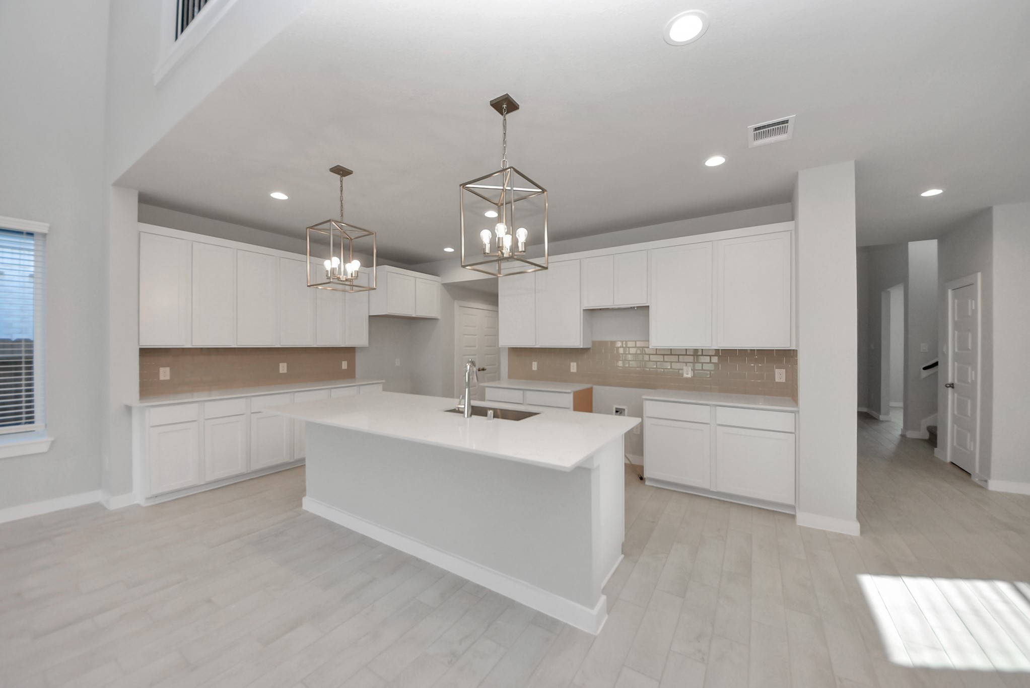 The kitchen is a culinary haven, featuring granite countertops, a tile backsplash, stainless steel appliances, 42 upper cabinets, and undercabinet lighting.