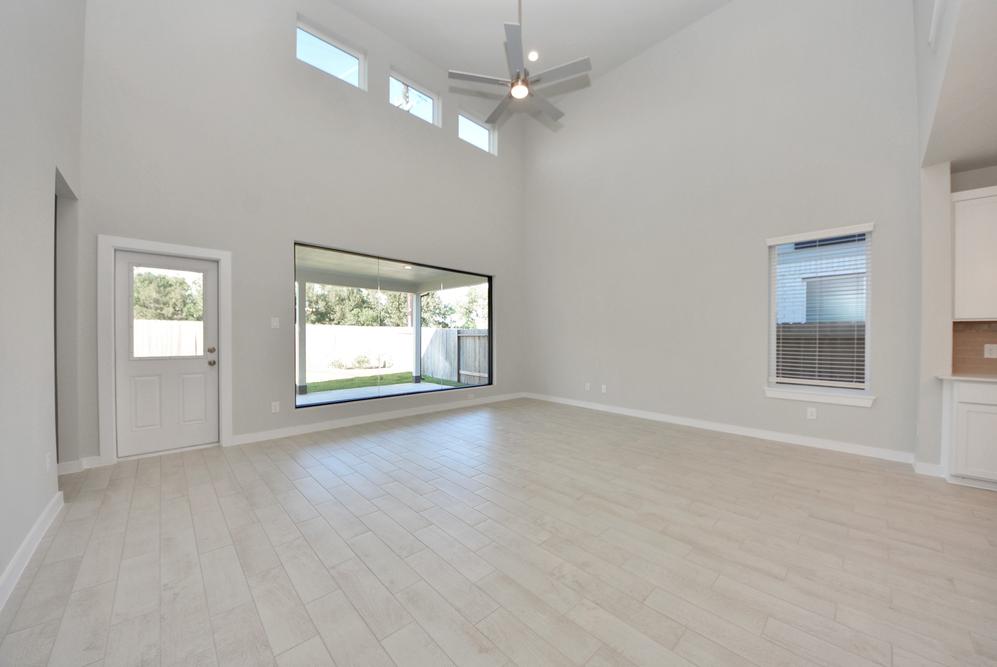 Gather the family and guests together in your lovely living room! Featuring soaring high ceilings, recessed lighting, ceiling fan, custom paint, gorgeous floors, and large windows that provide plenty of natural lighting throughout the day.