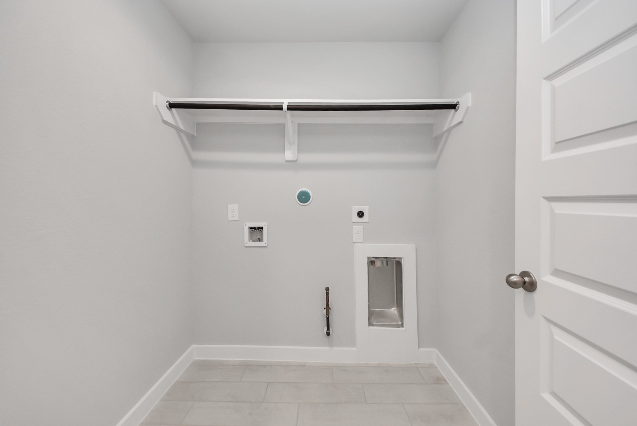 A perfect blend of functionality and comfort. Capture the essence of easy living with a first-floor laundry room, thoughtfully equipped with shelving for effortless organization. Both electric and gas connections available.