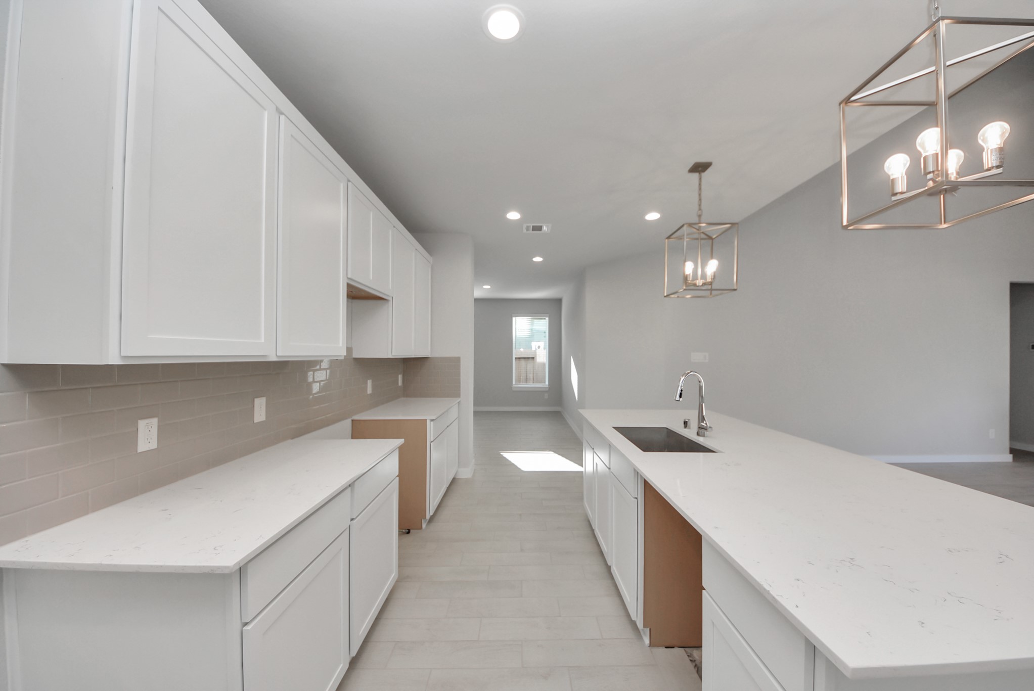 This kitchen is truly a chef's dream! This haven Boasts high ceilings, recessed & pendant lighting, stained wood cabinets, granite countertops, stainless steel appliances, a modern tile backsplash.  All of this overlooks your expansive family room, creating a perfect space for culinary delights and family gatherings.