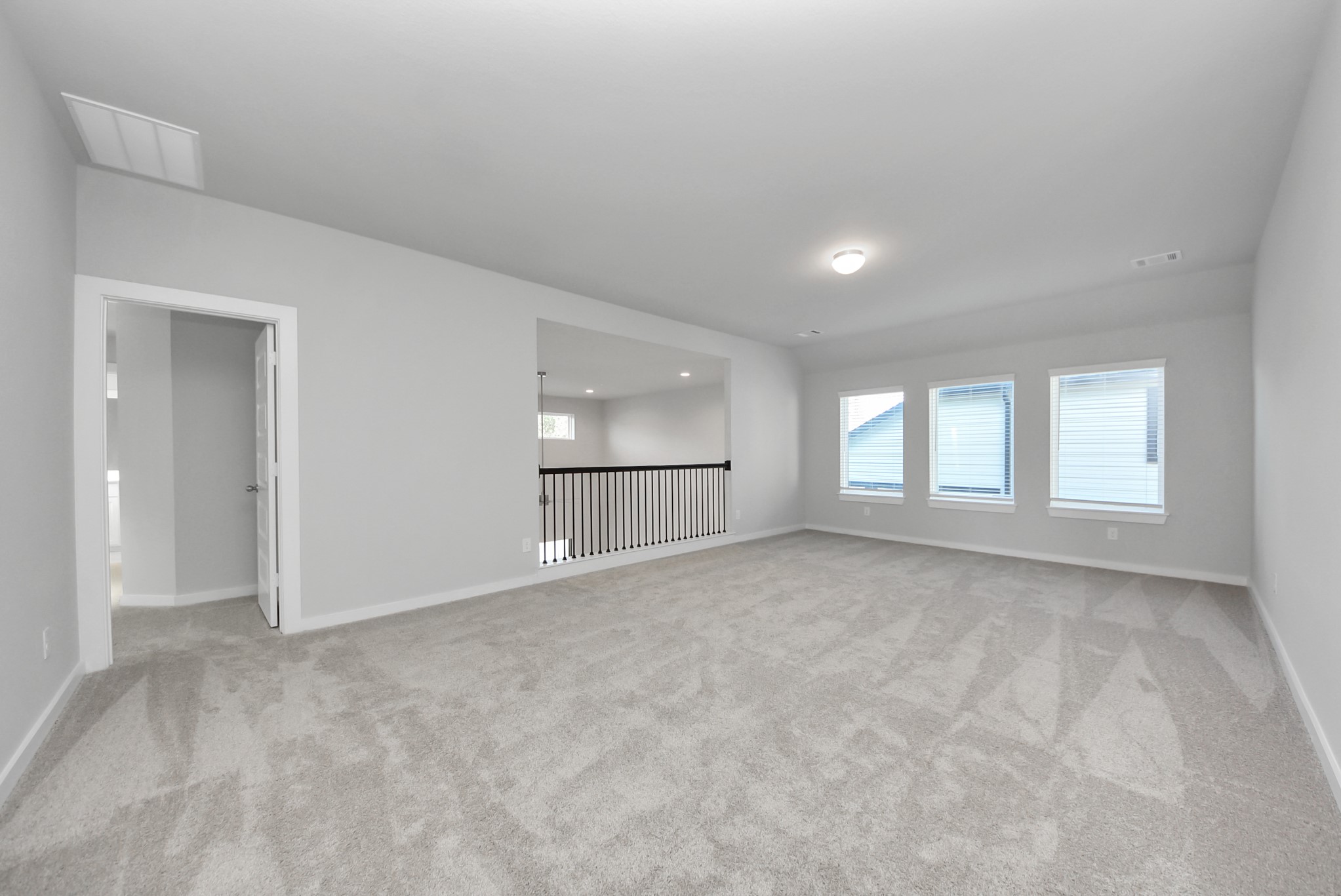 Come upstairs and enjoy a day of leisure in this fabulous game room! This is the perfect hangout spot or adult game room! Features plush carpet, high ceilings, custom paint and windows for plenty of natural light.