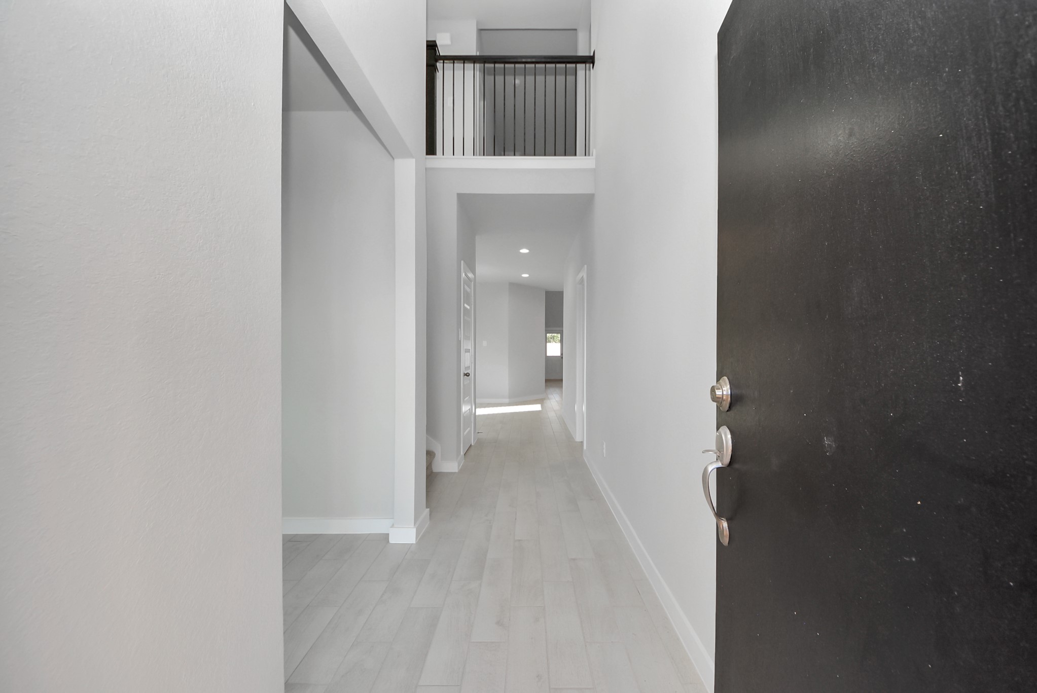 As you step into the threshold of this luxurious home, you'll soon be welcomed by an elegant glass door (to be installed). Inside, soaring ceilings amplify the spaciousness, while the refined wood-look tile flooring and oversized baseboards exude sophistication and charm. As you step into the threshold of this luxurious home, you'll soon be welcomed by an elegant glass door (to be installed). Inside, soaring ceilings amplify the spaciousness, while the refined wood-look tile flooring and oversized baseboards exude sophistication and charm.