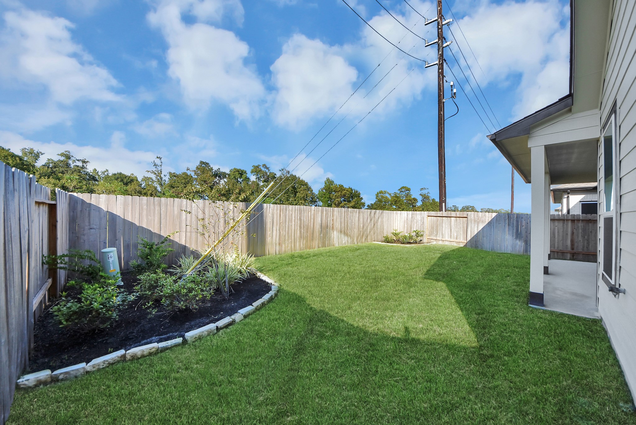 Discover the expansive backyard and its inviting covered patio  a perfect haven for both playtime for the kids and relaxation for adults. This outdoor space is an ideal canvas for your outdoor living dreams, complete with room for patio furniture, a BBQ pit, and endless possibilities for creating your own personalized oasis. Note: sample product photo. Actual exterior and interior selections may vary by homesite.