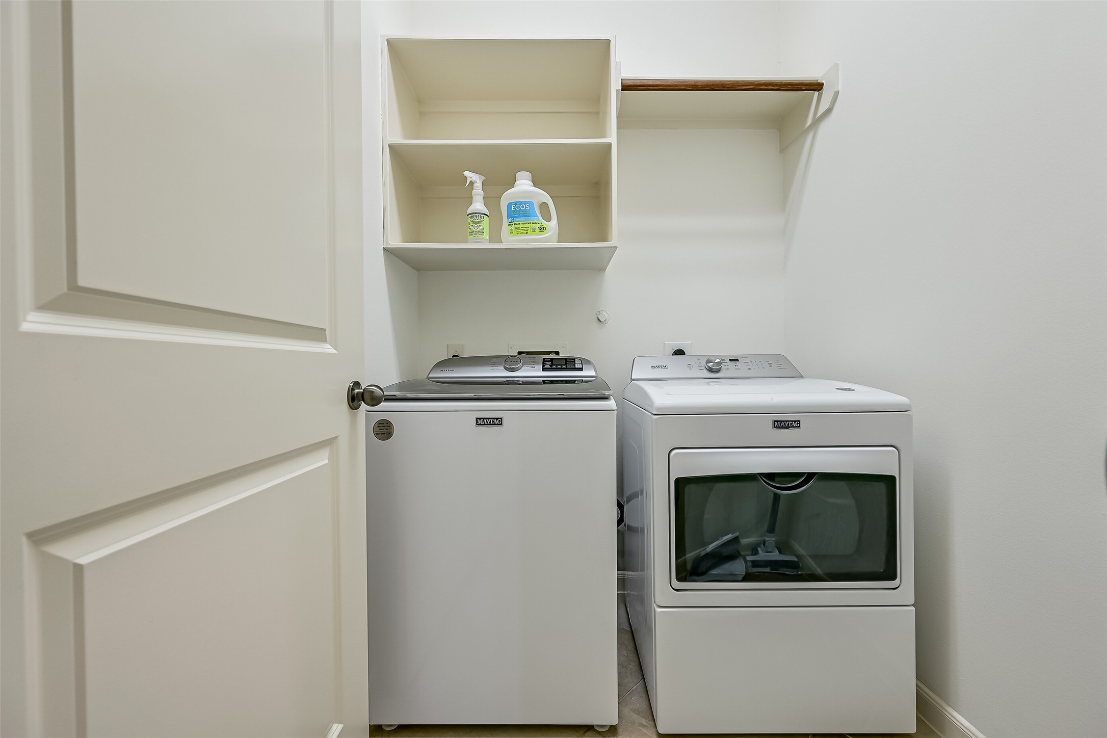Conveniently located off the interior hallway, the utility room accommodates a full-size washer & dryer with open shelving above for laundry supplies. Additional hanging space provides extra functionality, while the home's thoughtful single-story layout keeps laundry duties close to the bedrooms.
