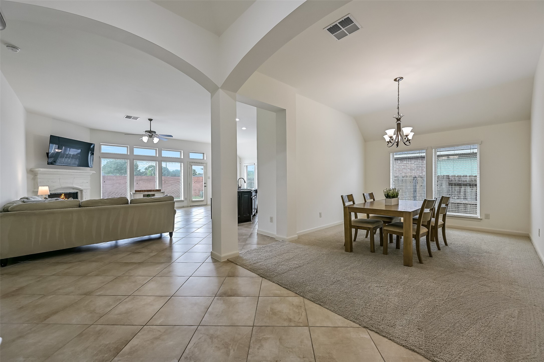 Just off the entry, the spacious formal dining room features a dramatic arched opening, neutral carpeting, an elegant chandelier & two large windows overlooking the side yard. Its open connection to the foyer & nearby family room makes this a welcoming space for holiday meals or special gatherings.