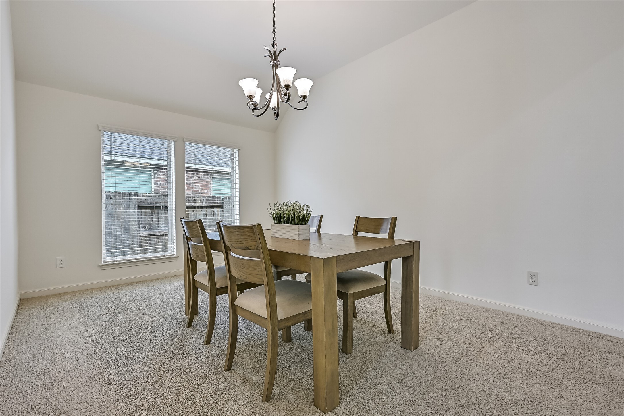 The formal dining room offers generous space for a full dining set, complemented by soft neutral walls, plush carpeting & a decorative chandelier. Two large windows with blinds invite natural light into the room, while the separate dining space provides flexibility for hosting family meals & celebrations.