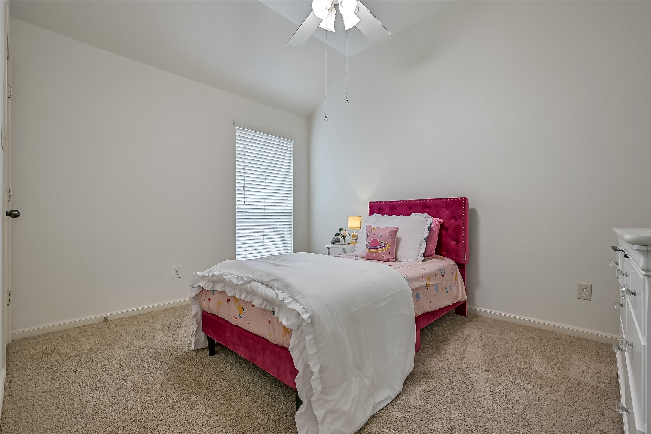 Another secondary bedroom located off the hallway features fresh paint, a ceiling fan & a walk-in closet, with a full bathroom conveniently situated between the secondary bedrooms.