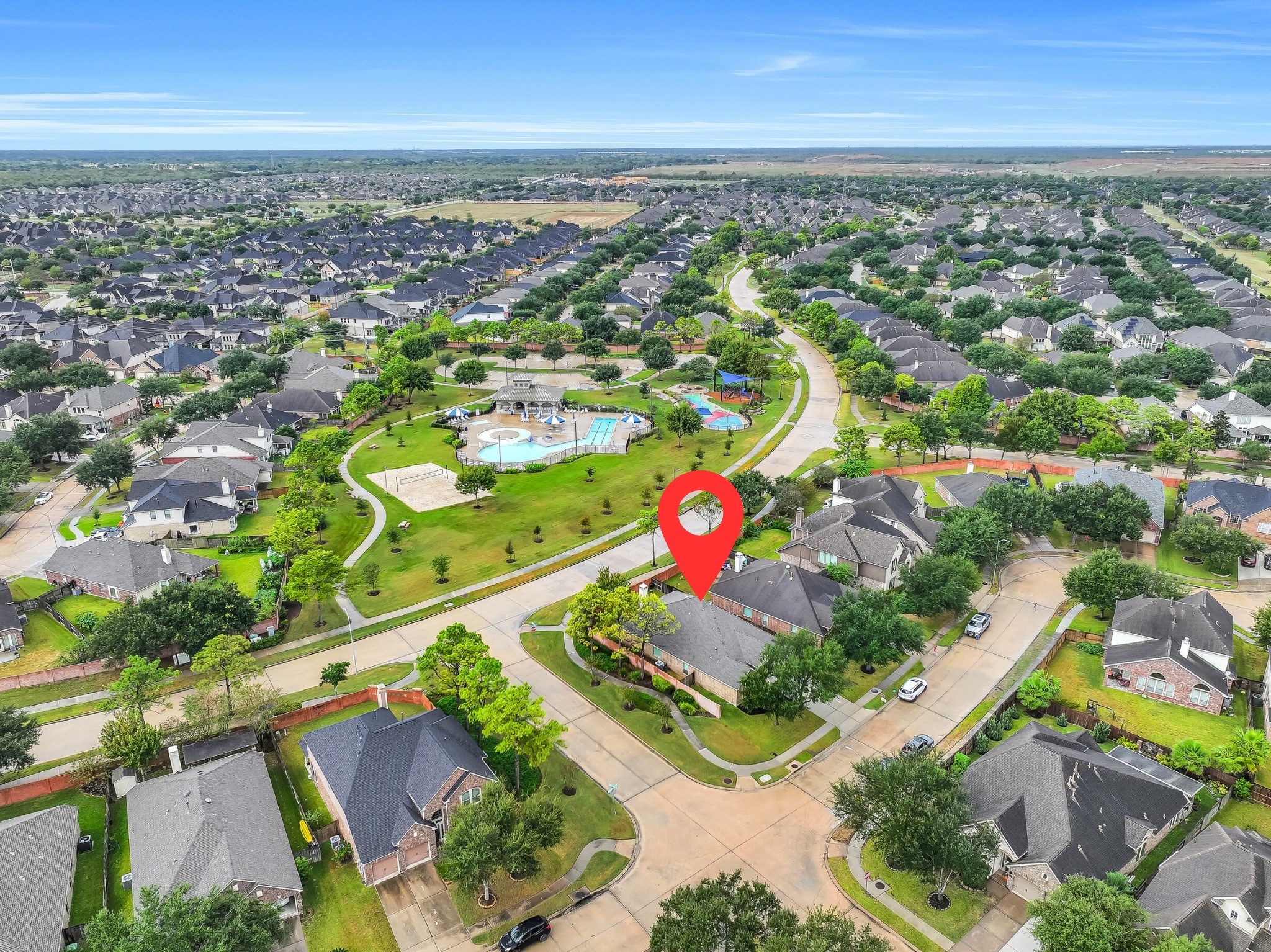 What a location! This aerial showcases 2818 Silhouette Bay on its desirable corner lot, directly across from Shadow Creek Ranch's beautiful community recreation area! Enjoy convenient access to the swimming pool, splash pad, playground, beach volleyball court & landscaped walking paths just steps from home.
