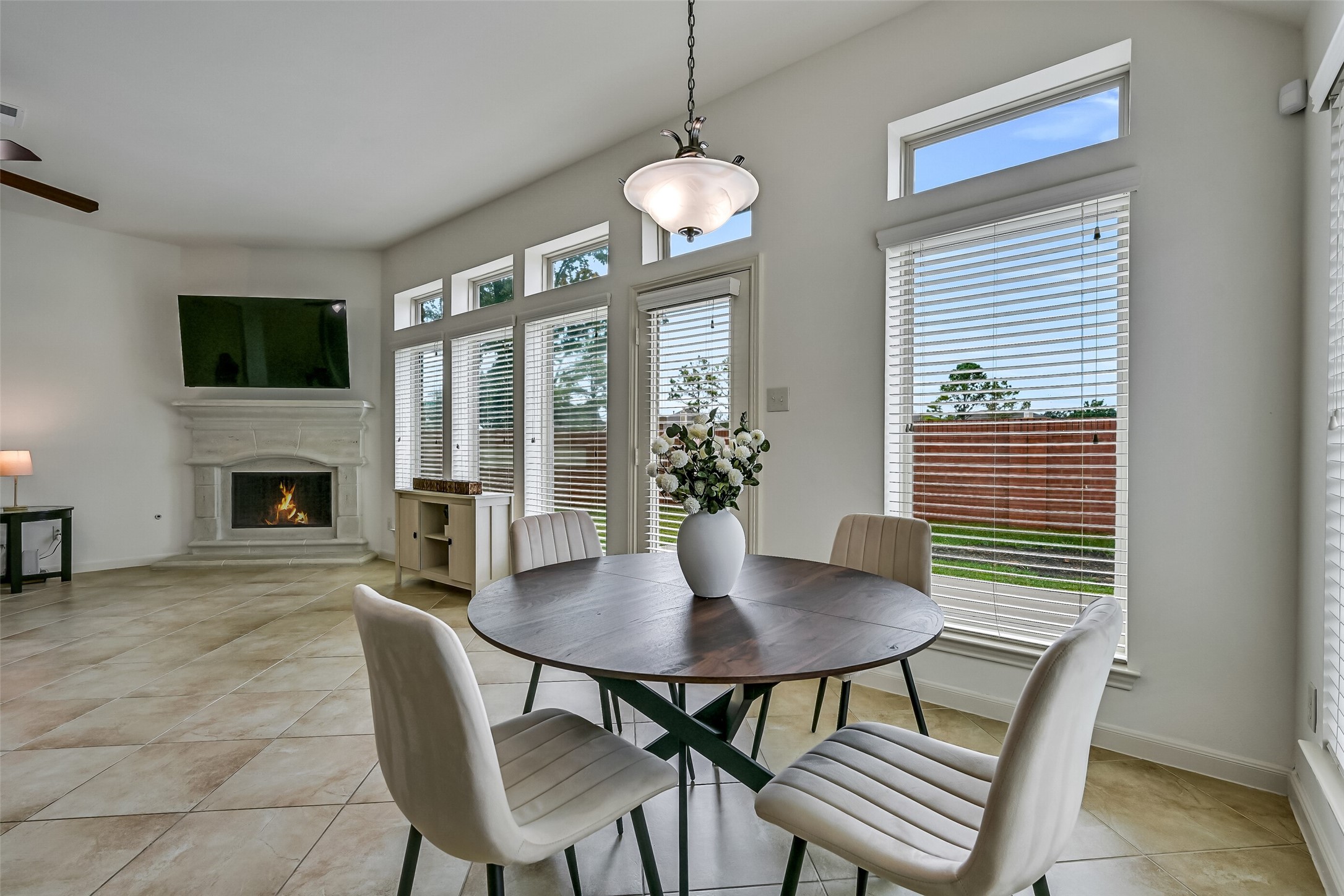 From the kitchen island, enjoy an open view of the family room with its beautiful fireplace & impressive wall of windows! The adjoining breakfast area overlooks the backyard, while the island's granite countertop provides a convenient gathering spot. An ideal layout for staying connected while preparing meals.