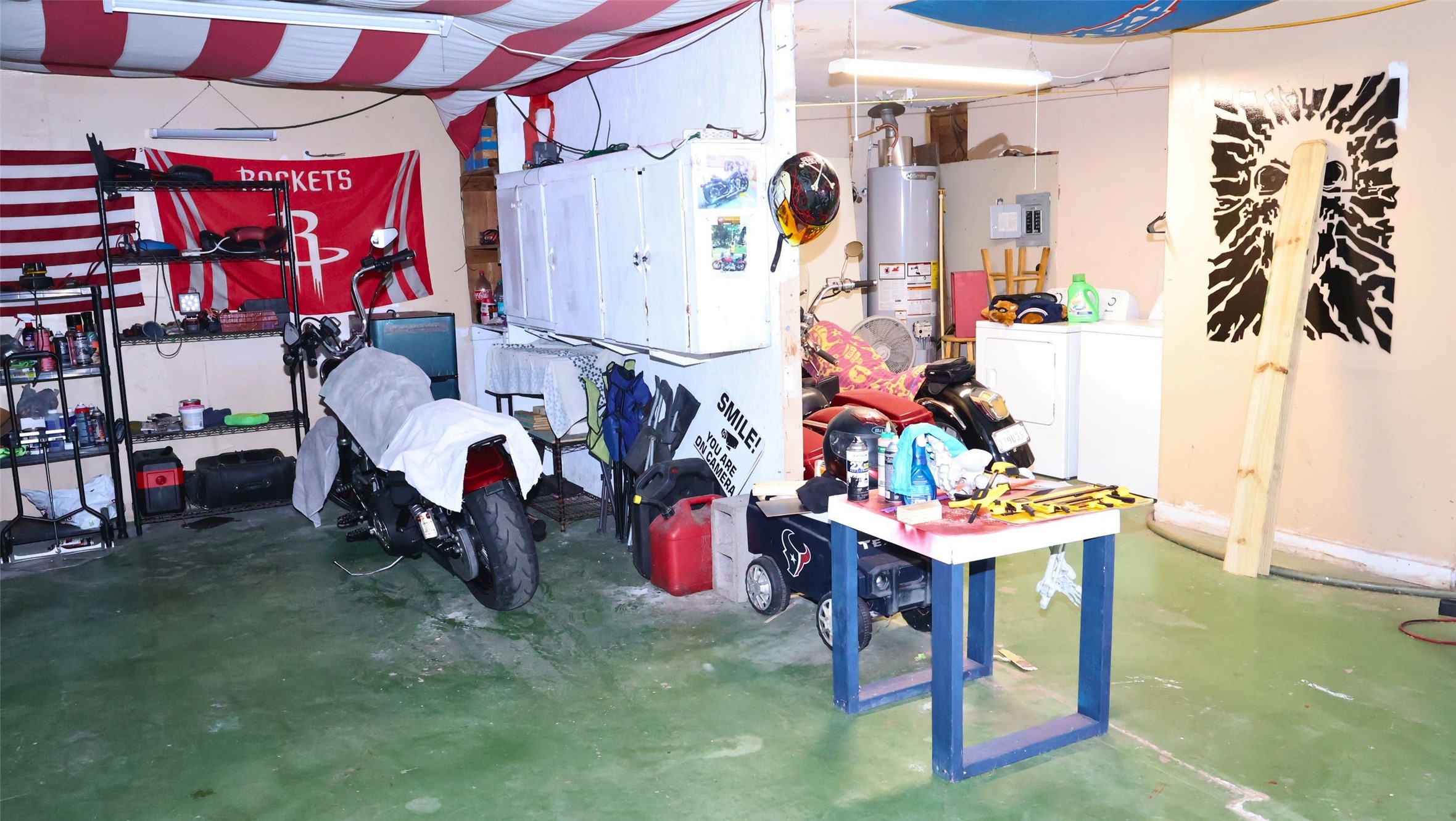 Spacious garage with ample storage, workbench, and utility area, perfect for hobbyists and DIY enthusiasts.