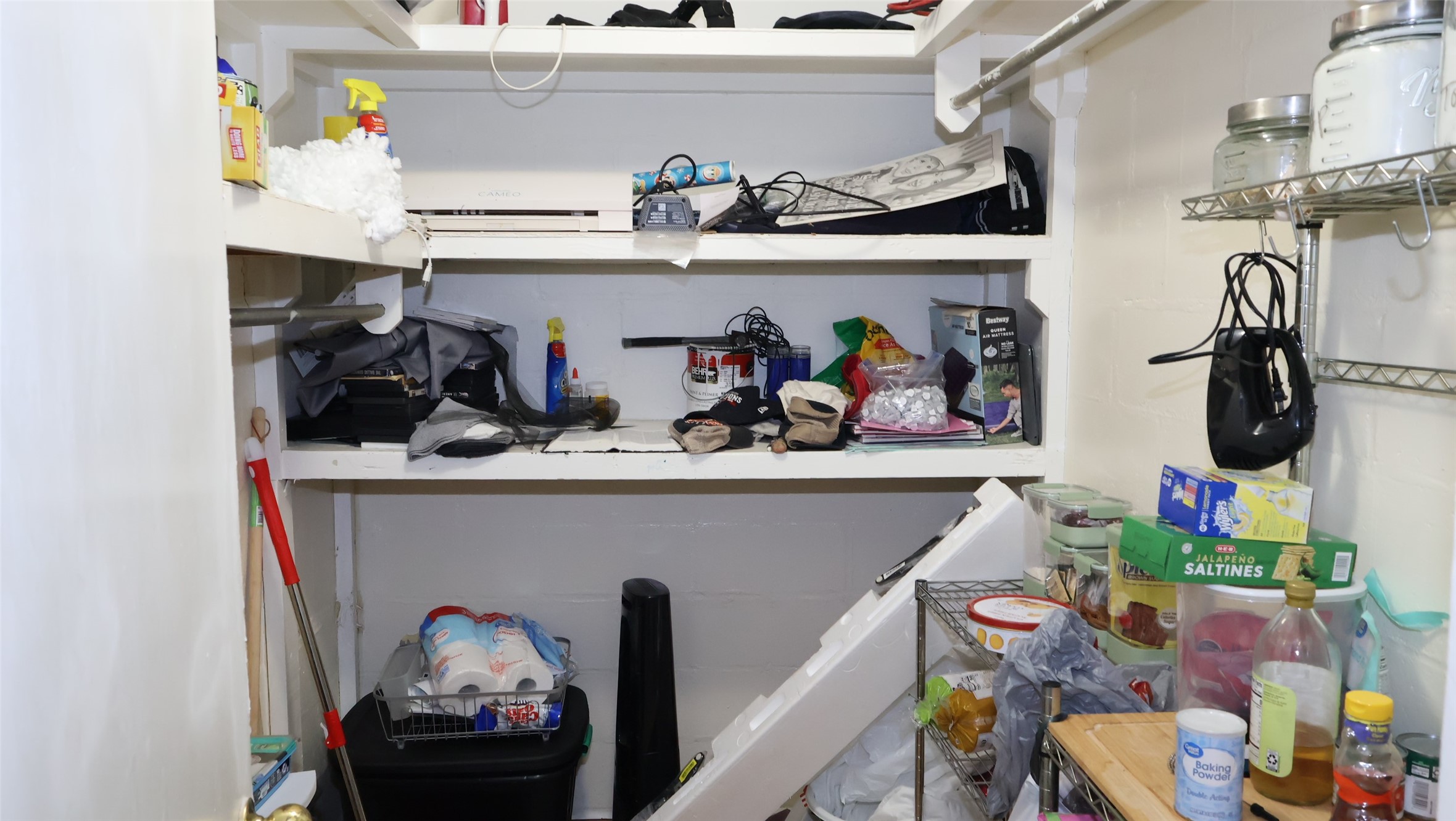 Spacious utility room with ample shelving and storage space, perfect for organizing household essentials and pantry items. Spacious utility room with ample shelving and storage space, perfect for organizing household essentials and pantry items.