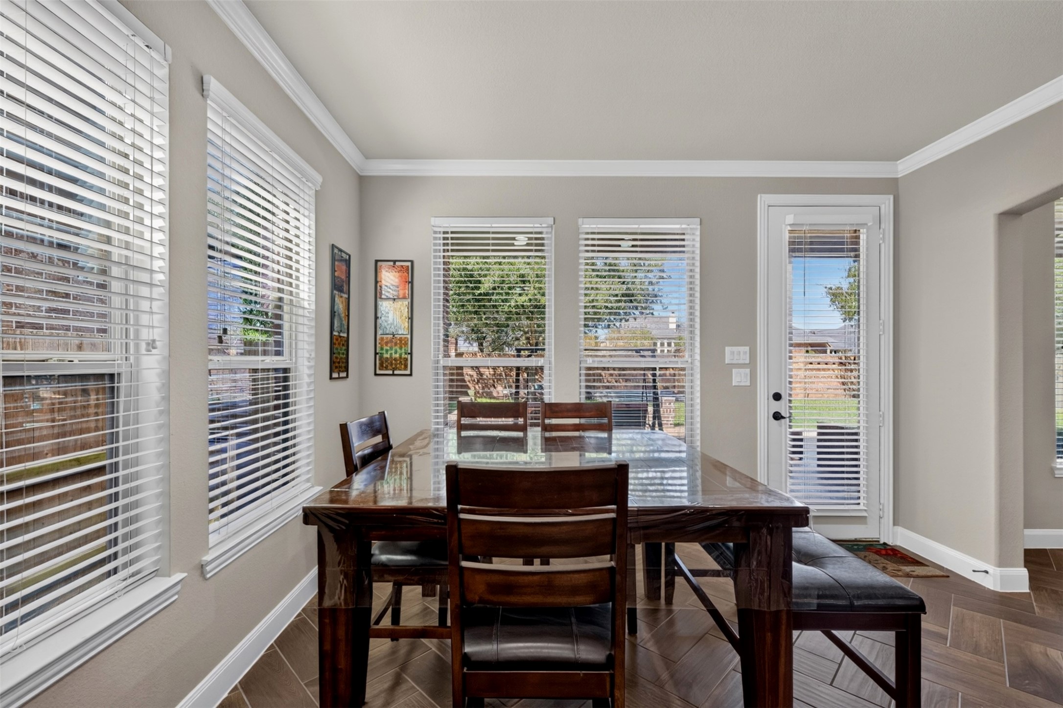 Enjoy everyday dining surrounded by natural light from the multiple windows. With a door leading outside, this inviting space makes it easy to transition from breakfast indoors to coffee or conversation on the patio.