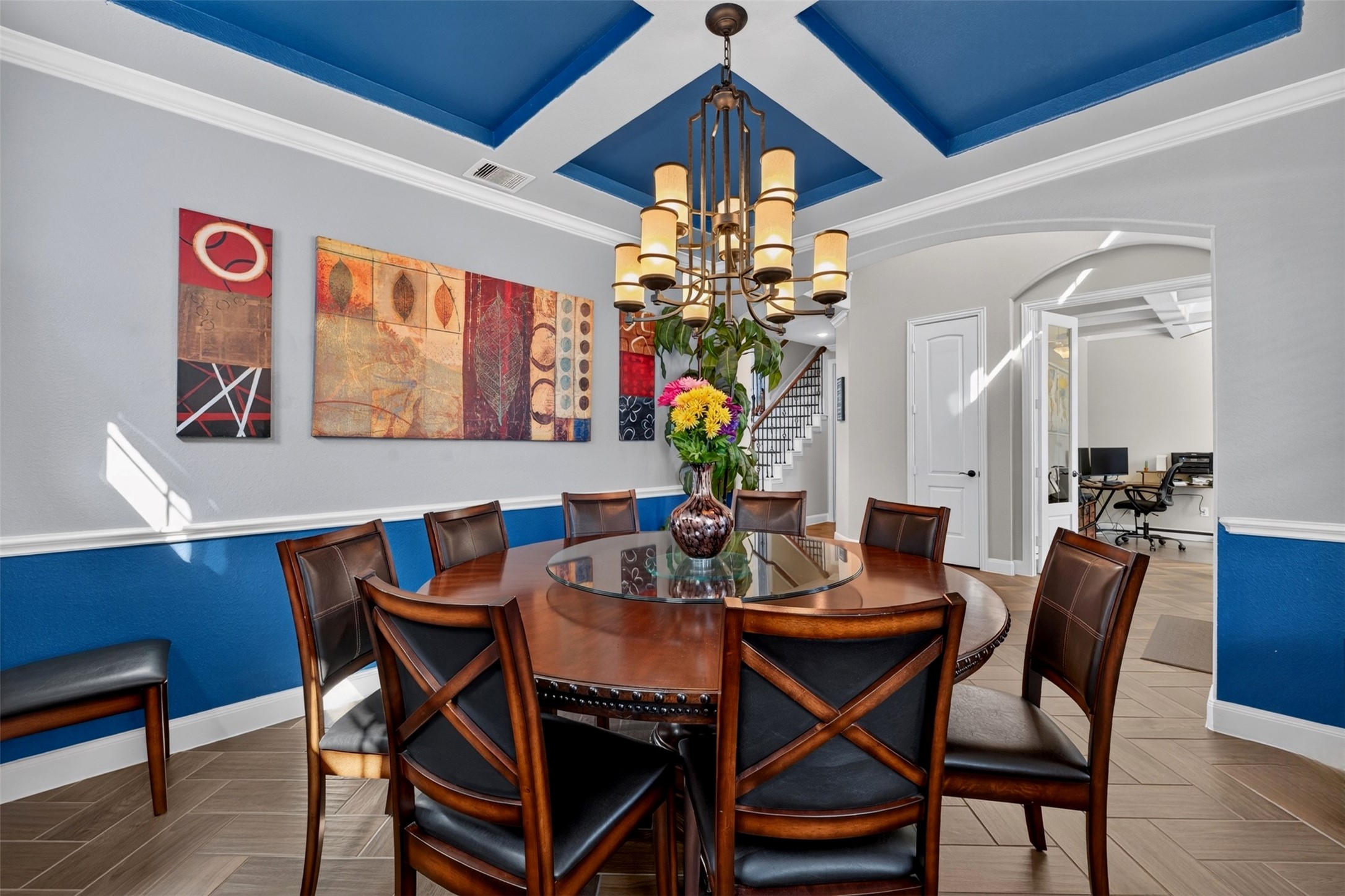 From another angle, the dining room's architectural details take center stage. The tray ceiling, decorative wall trim, and open connection to the entry and adjoining spaces create a polished atmosphere for entertaining.