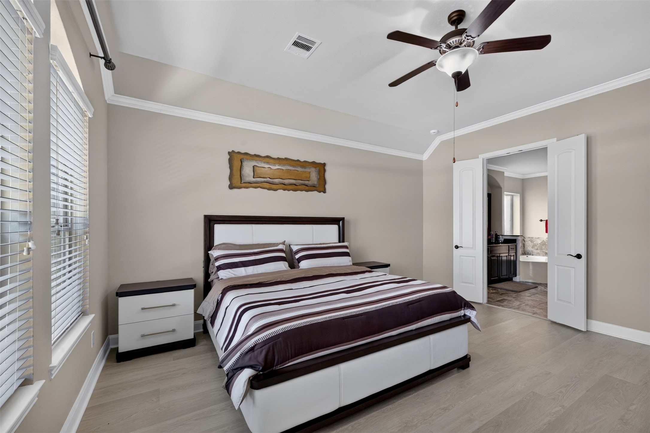 A closer look reveals the bedrooms generous proportions, with plenty of room to relax and unwind. The double-door entry to the ensuite bath adds convenience and an easy flow between spaces.