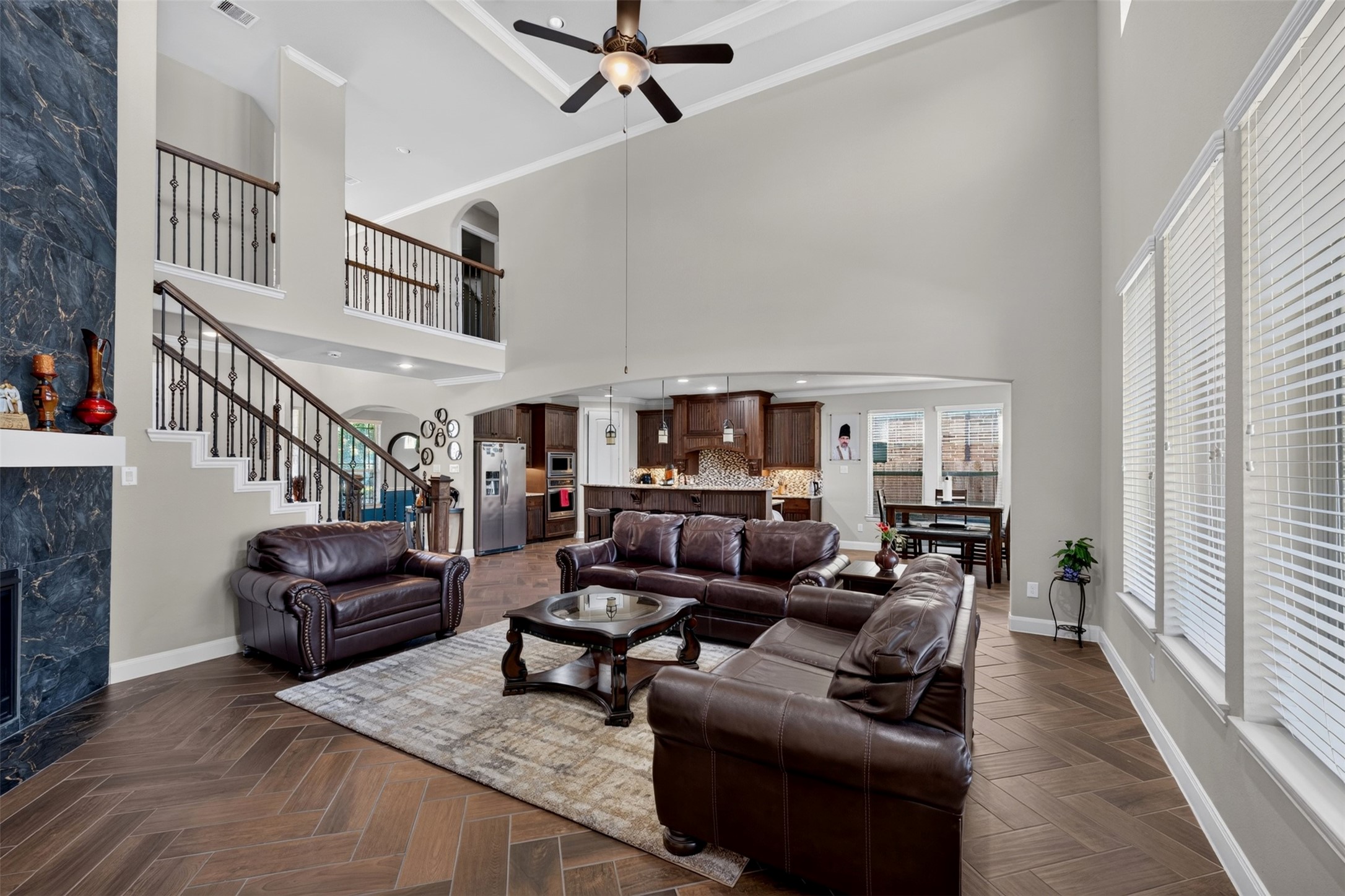 This wider view showcases the seamless connection between the family room and kitchen. The open-concept design encourages easy conversation and entertaining.