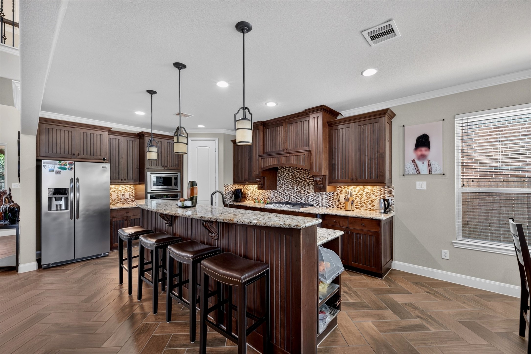 The kitchen flows effortlessly into the breakfast area, creating an inviting space where meal preparation and everyday dining come together.