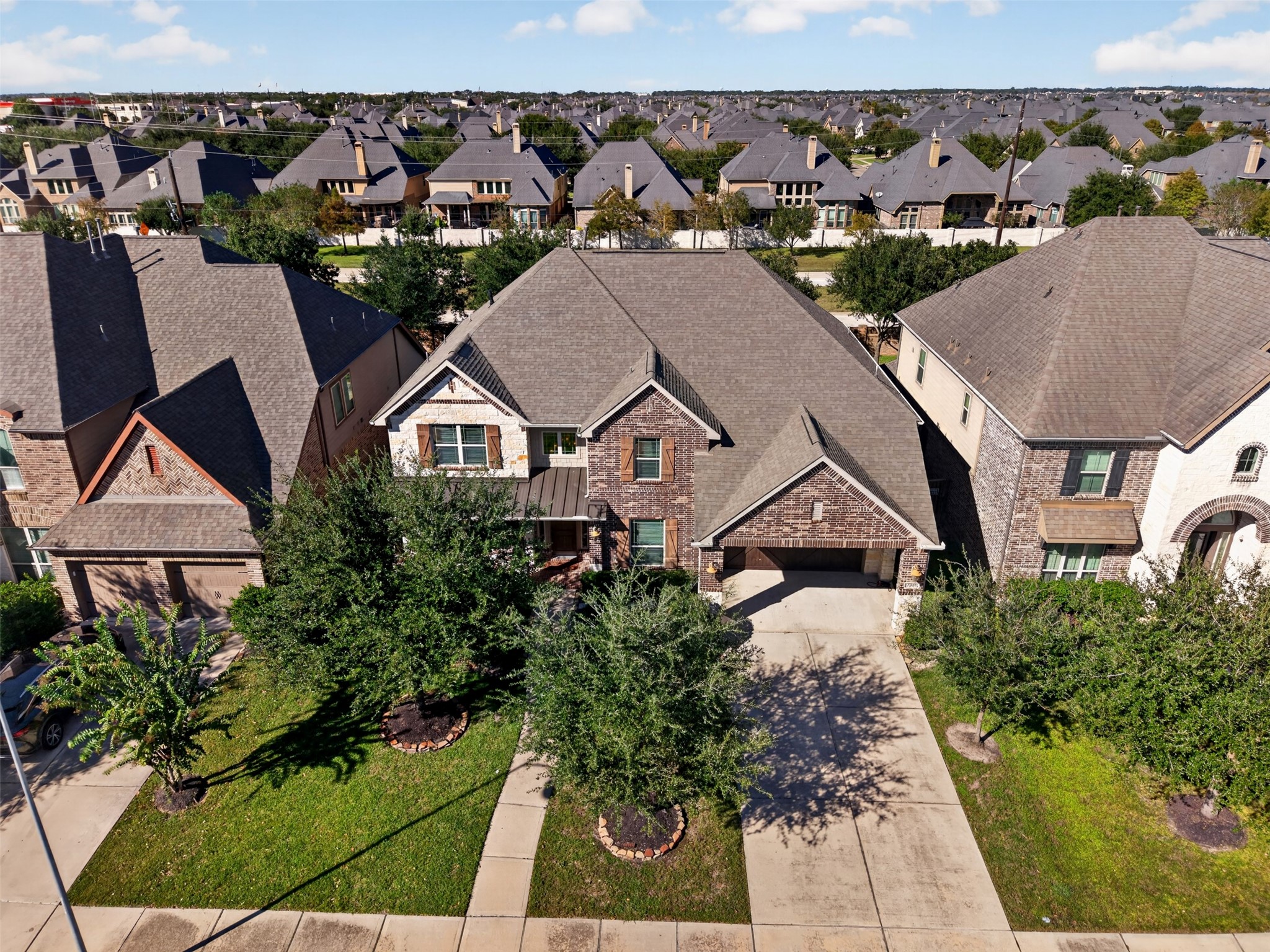 From above, appreciate the home's impressive rooflines, attractive exterior, and beautifully maintained front lawn. The established neighborhood setting adds to the appeal.