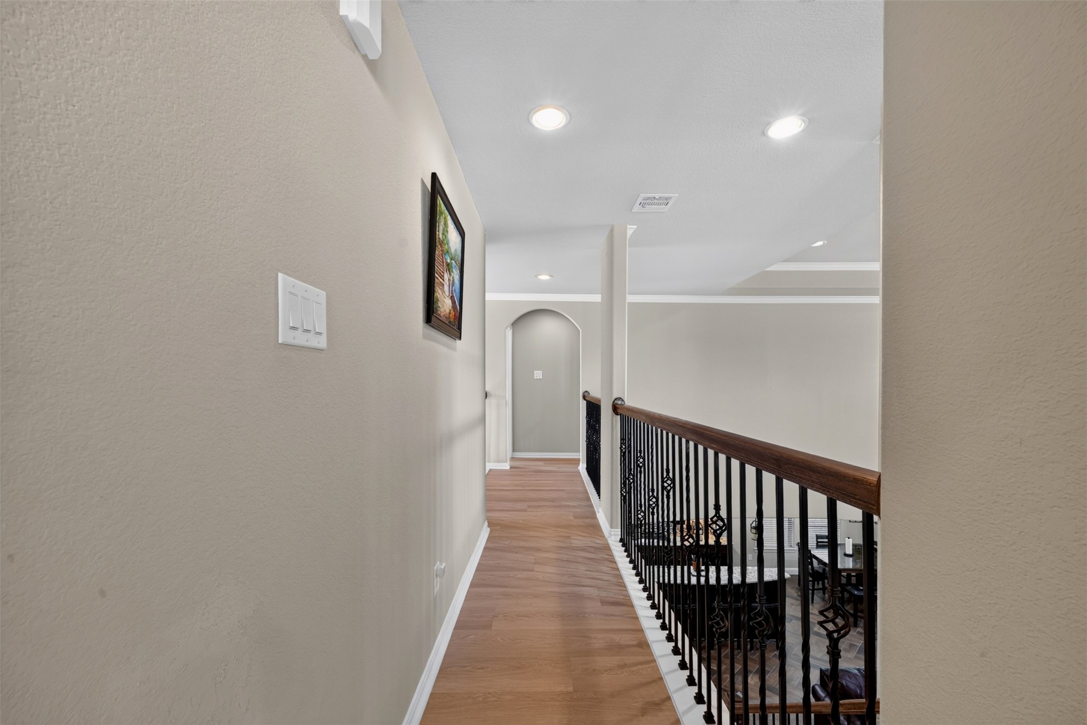 The upstairs landing connects the secondary living spaces while overlooking the main foyer below.
