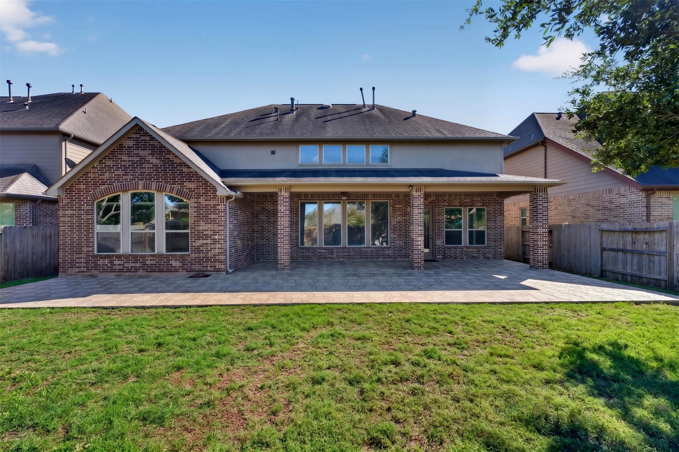 The back of the home welcomes you to a spacious outdoor retreat.