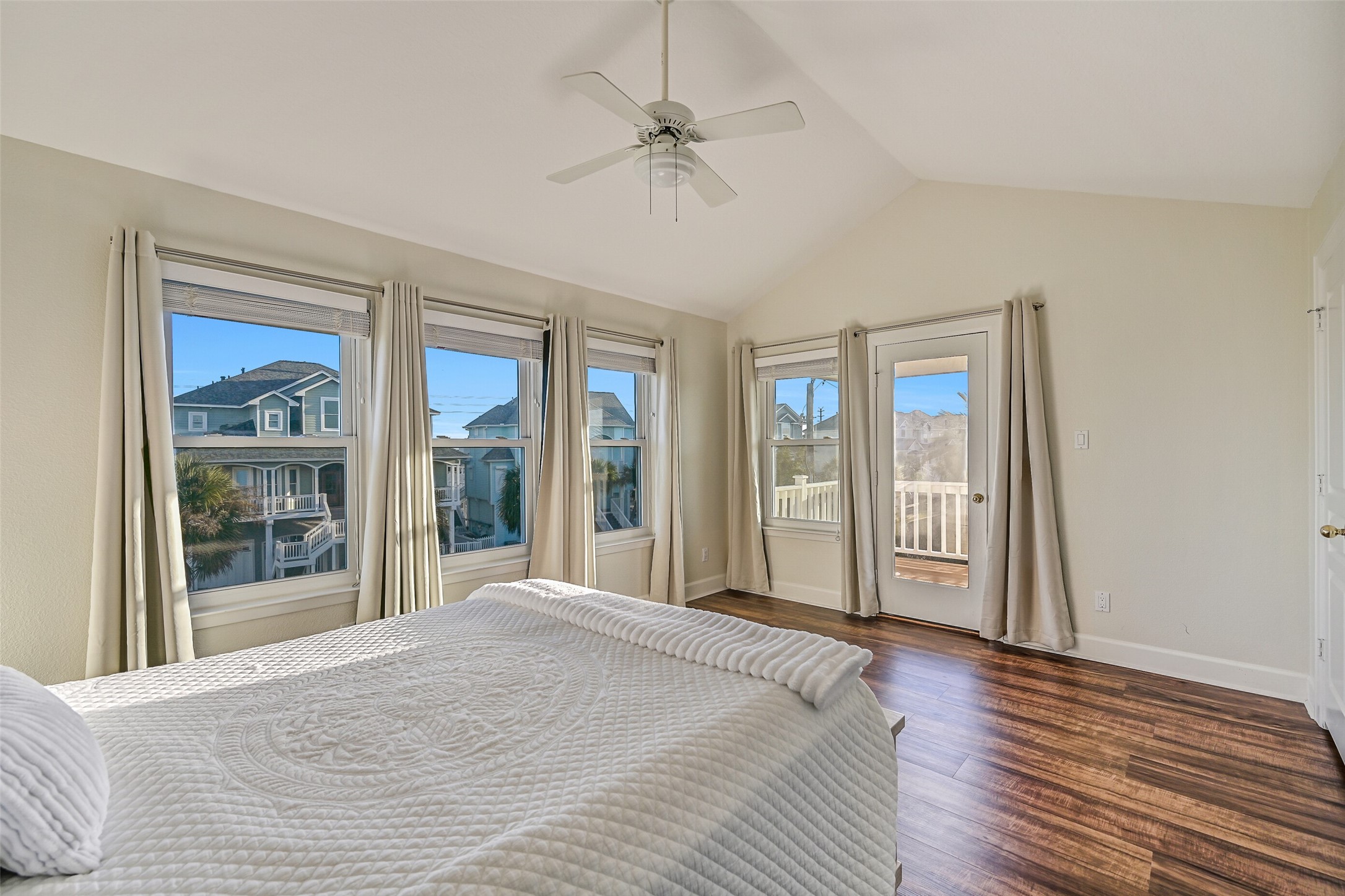 Notice the walls of windows that bring in abundant natural light. The door across the room provides access to the covered deck.
