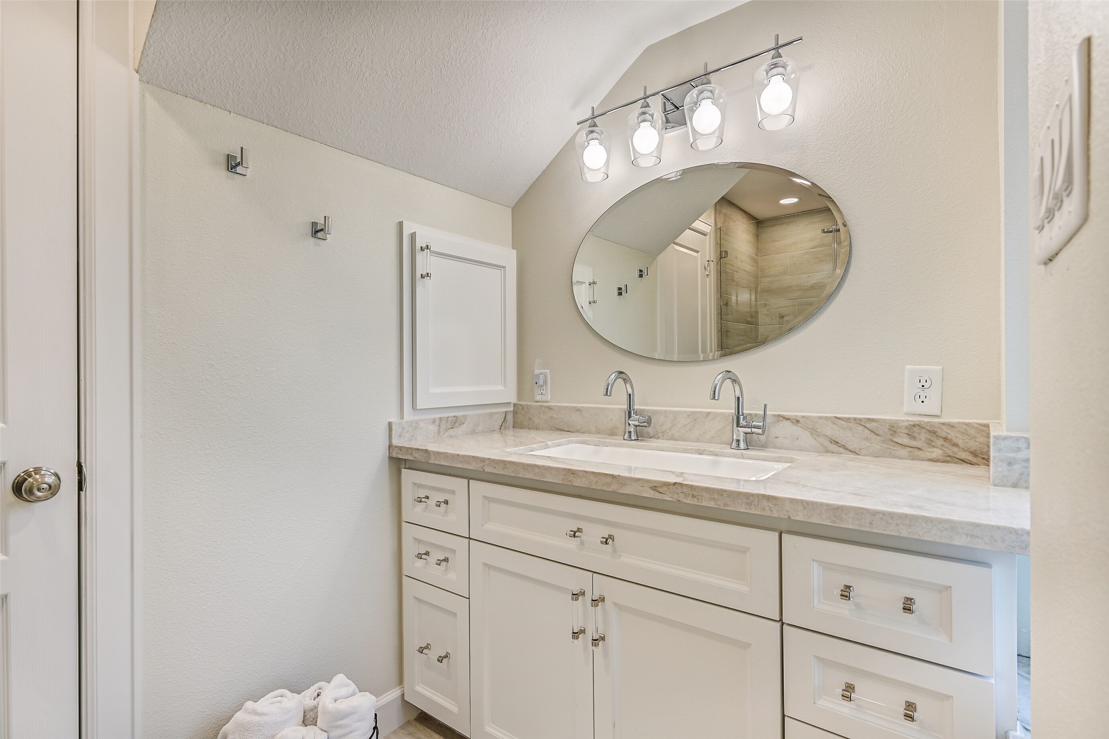 The en-suite bathroom offers marble countertops and a steam shower