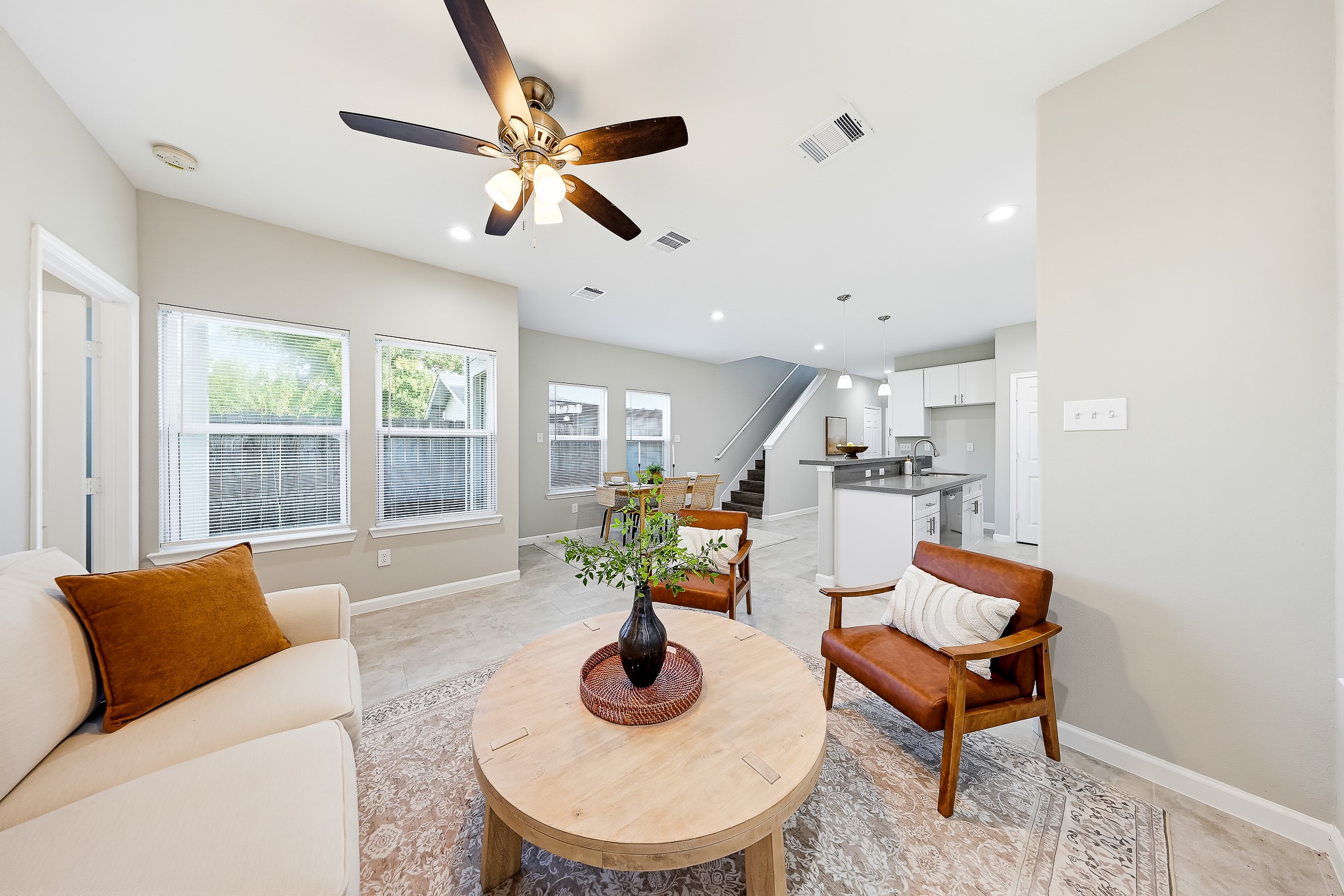 Sunlit windows create a cheerful backdrop for conversation, reading, or a quiet afternoon.