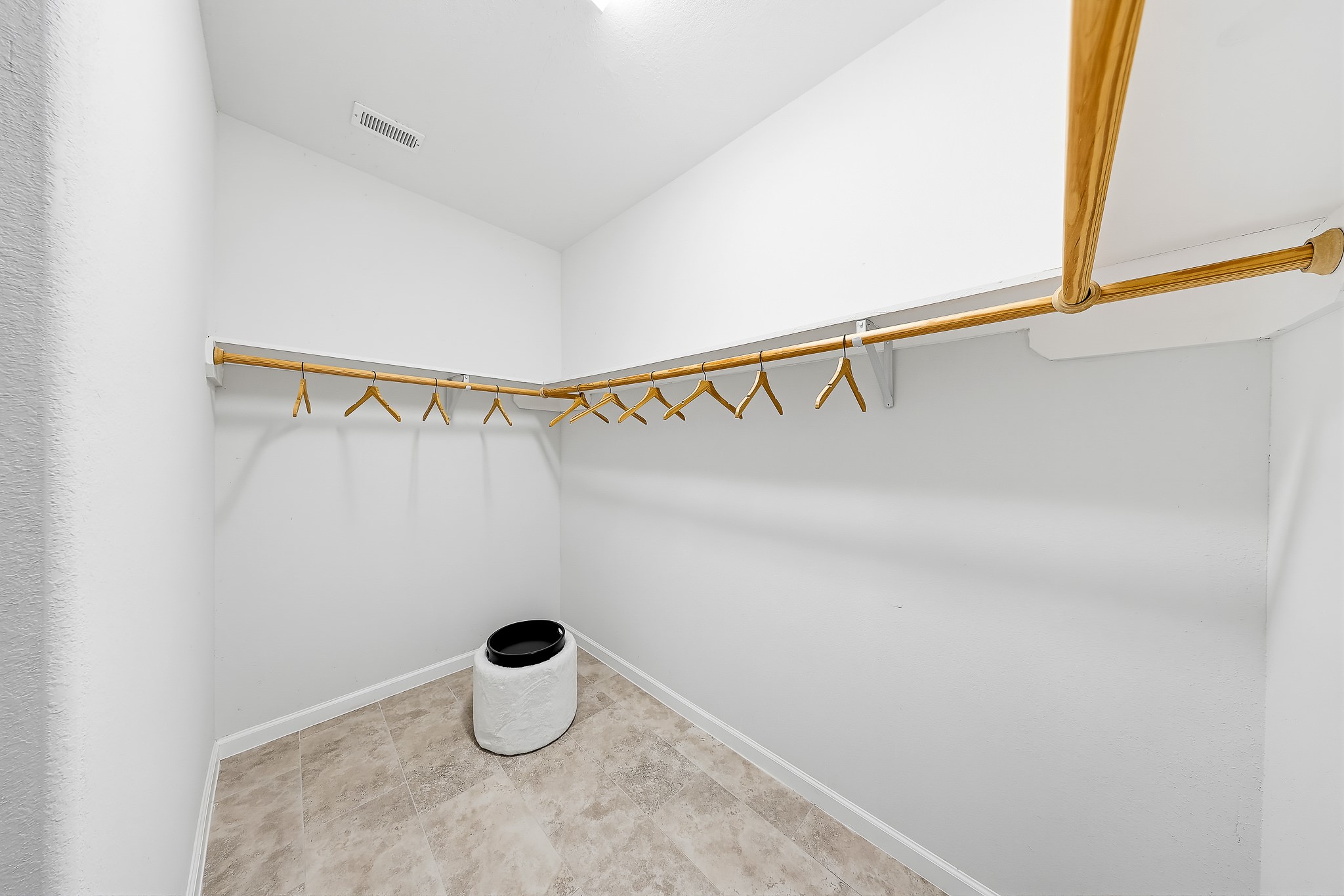 Keep your wardrobe organized and your bedroom serene with a walk-in closet.
