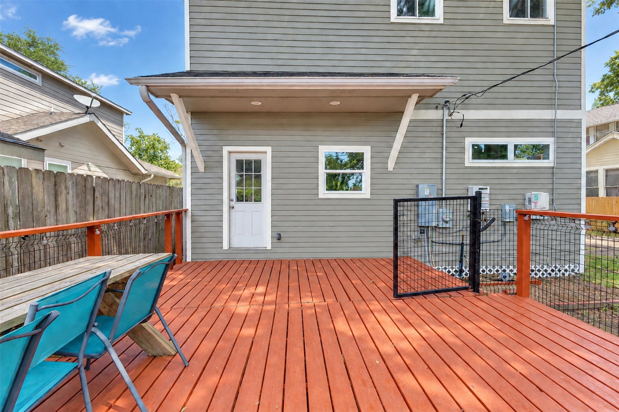 Spacious backyard deck with modern railing and ample seating, perfect for outdoor gatherings and relaxation.