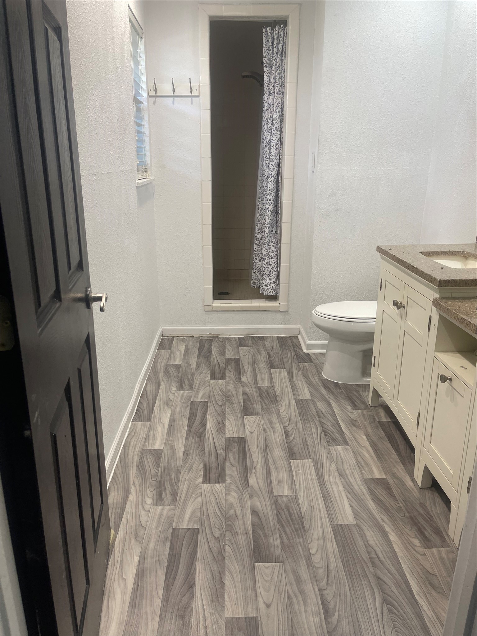 Primary en-suite bathroom with updated double sinks and walk-in shower