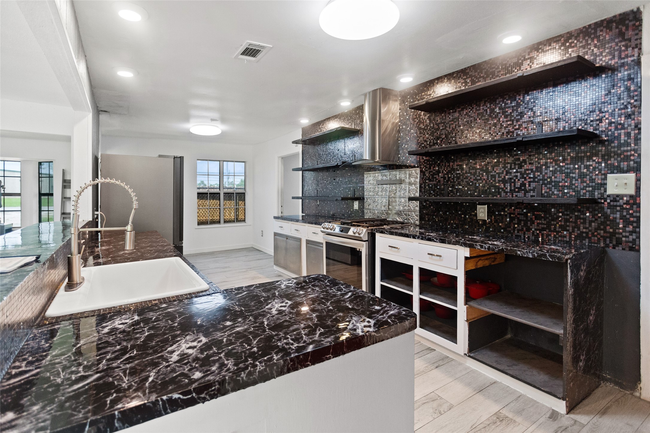 Plenty of room in this sleek kitchen with room for a breakfast table by the window to enjoy the morning light!